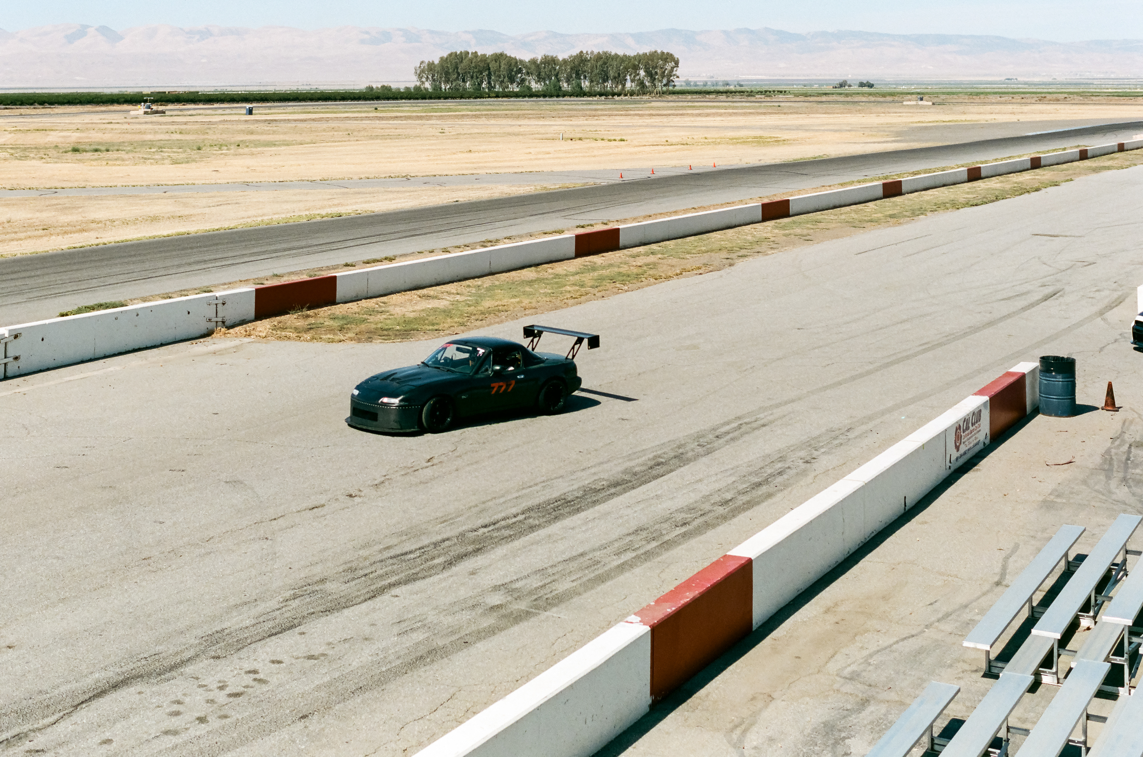 Cy And Kermit On Track: Cyrus and Kermit hit the track for their first session of the increasingly hot day. Cyrus Legg spends the day practicing his performance driving skills in his Mazda Miata, named Kermit, at Button Willow Raceway Park  July 29, 2023 - Buttonwillow, CA - Photo by Aaron Guy Leroux