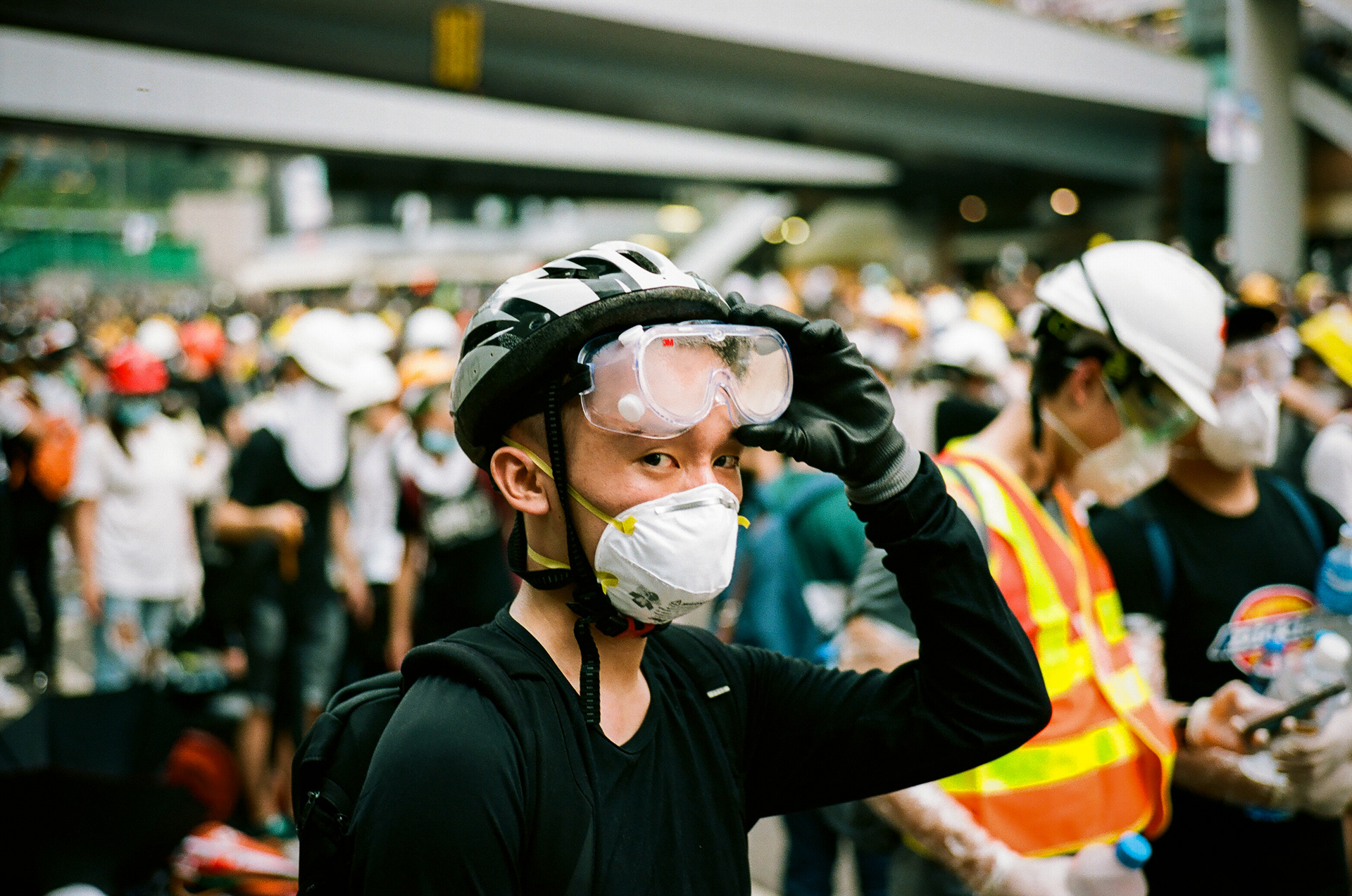 A young man waits through a lull in the days violence. Citizens of Hong Kong have taken to the streets in order to fight a new proposed law, that would allow for Hong Kongers arrested in the city to be extradited to China. June 12, 2019 - Hong Kong, 35mm