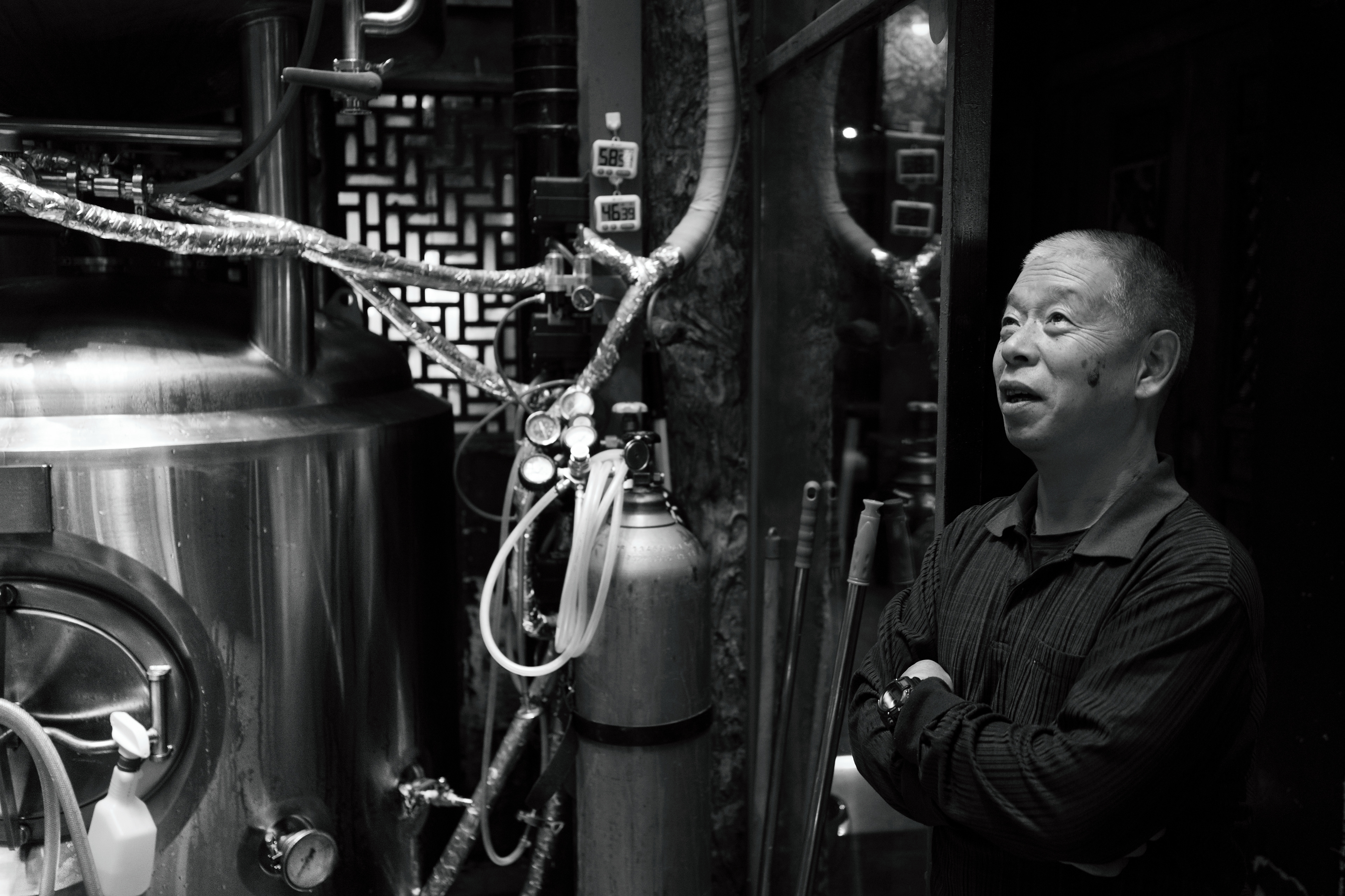 Brewmaster chatting with his protégé while they wait to pump the brew upstairs.