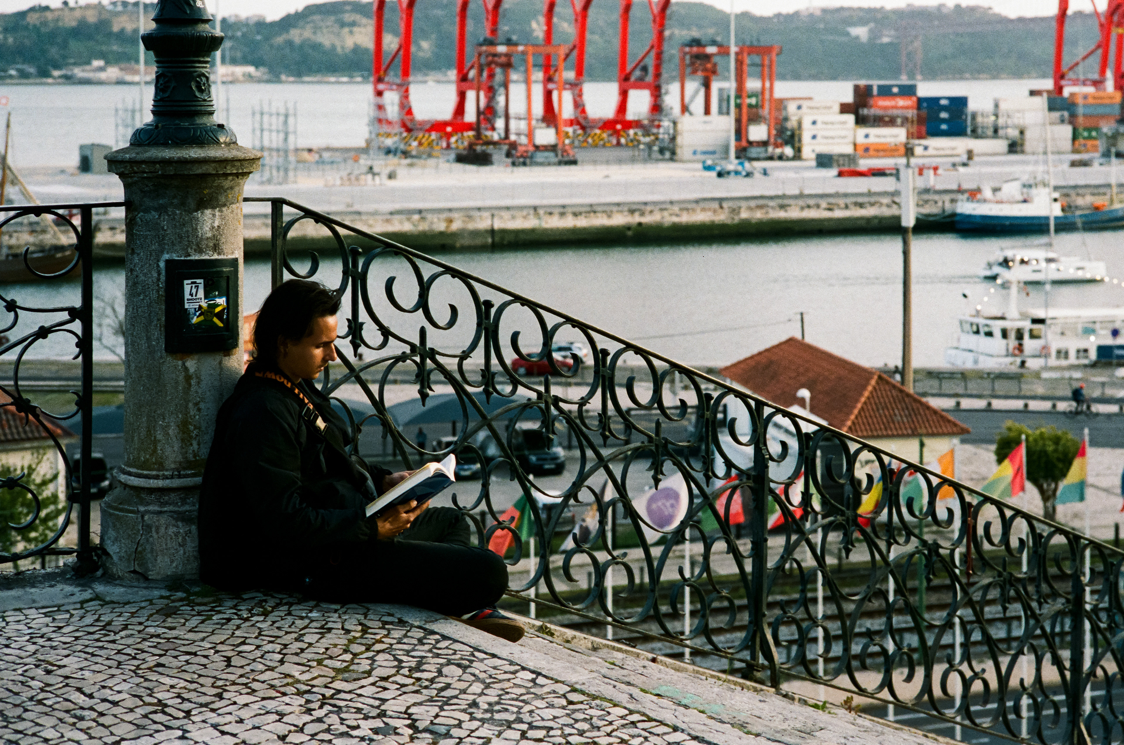 Reading 2: A young man reads on the steps just outside the Museu Nacional de Arte Antiga. March, 2023-Lisbon, Portugal-Photo by Aaron Guy Leroux