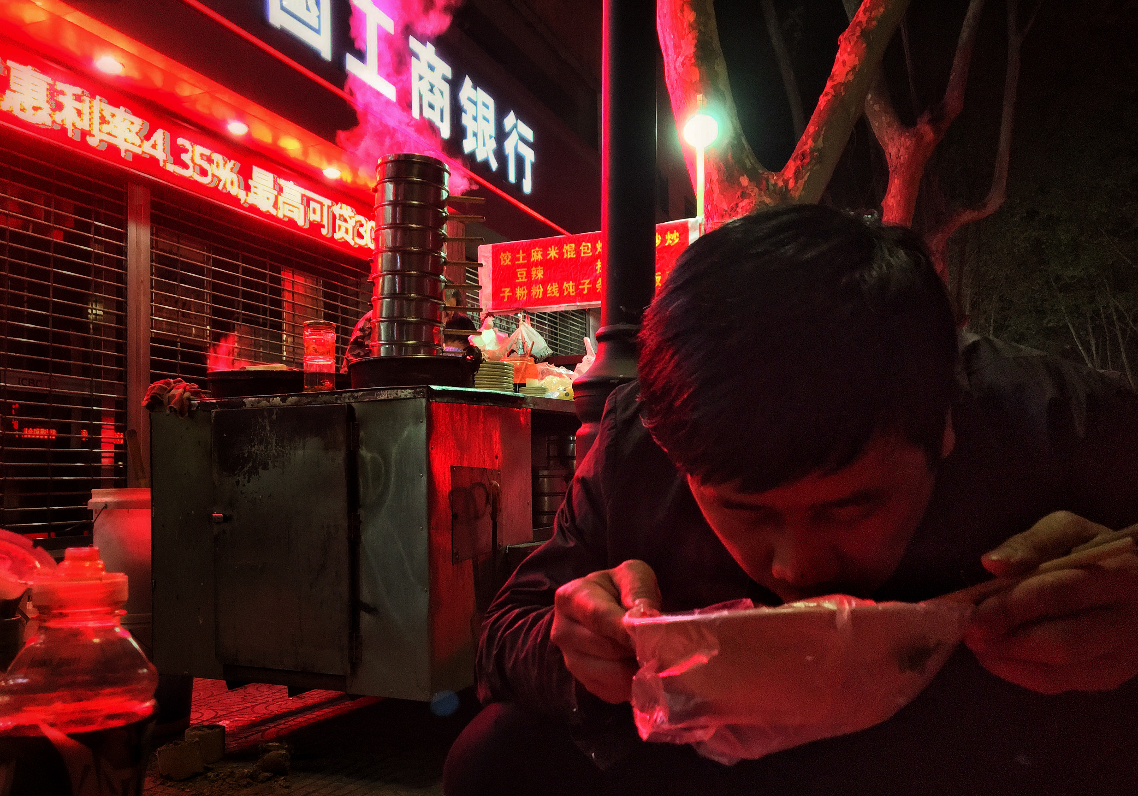 Street food with a stranger on another red night in Xi'an.