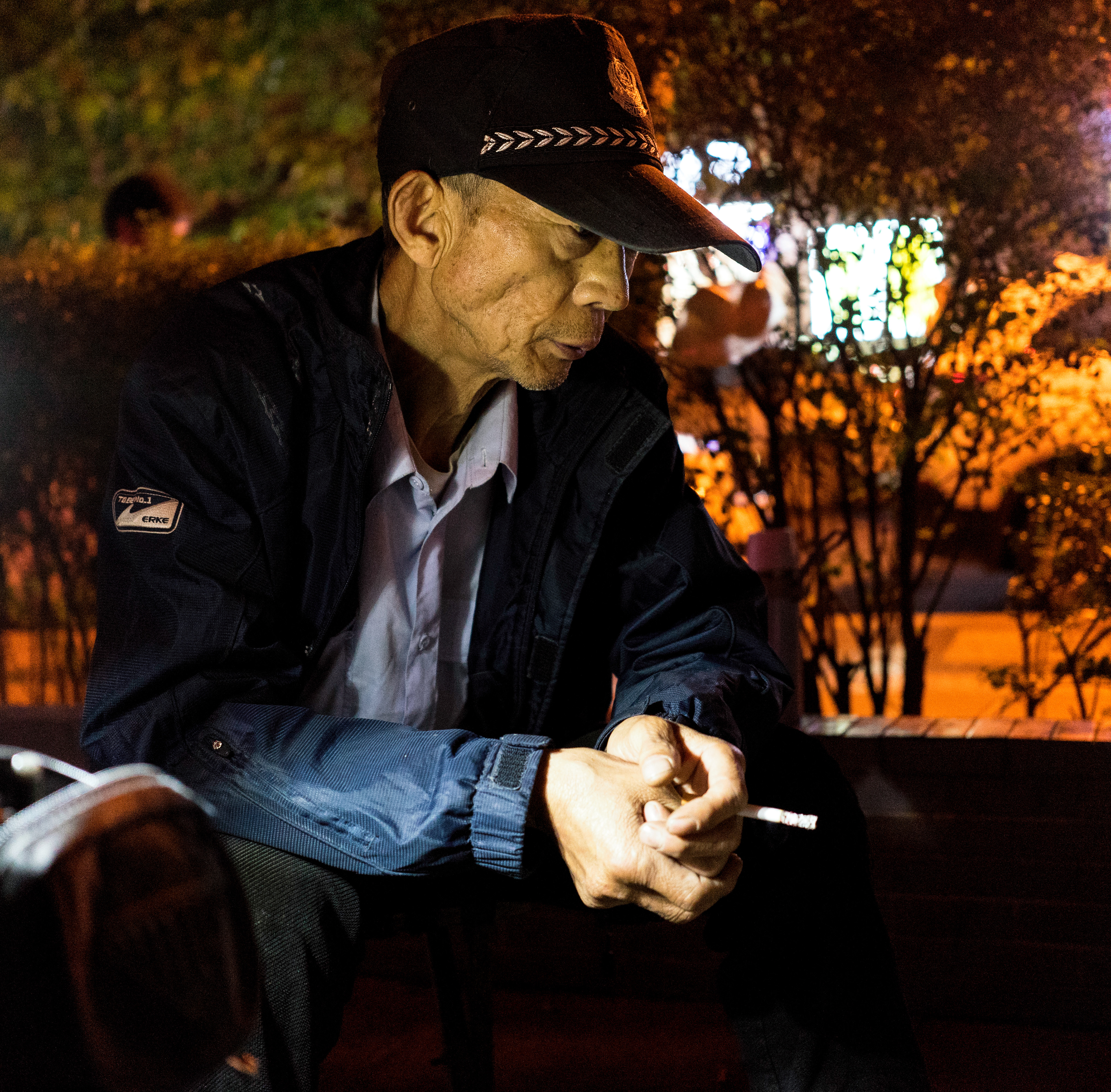 The Key Master: This key maker watches a pick-up game of Chinese chess from his little makeshift key shop on a dark sidewalk.