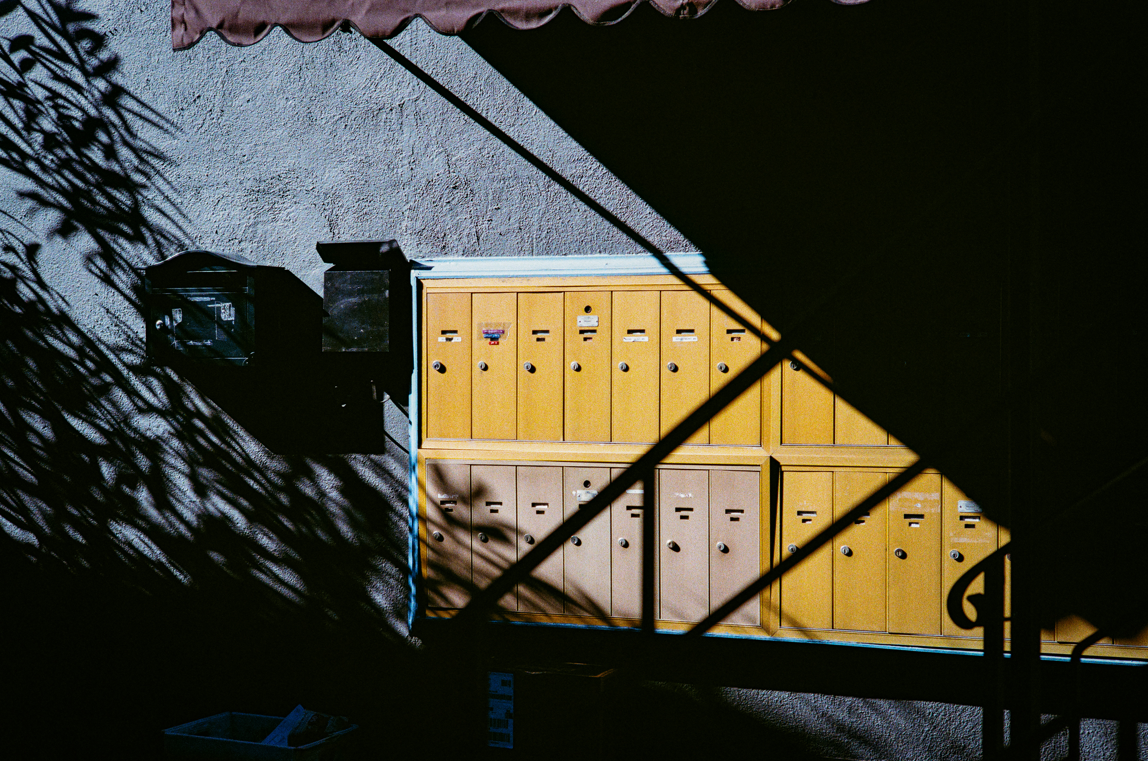Dark Mailbox: Our mustard mailboxes at Amherst Gardens apartments. February, 2023-Sherman Oaks, CA-Photo by Aaron Guy Leroux
