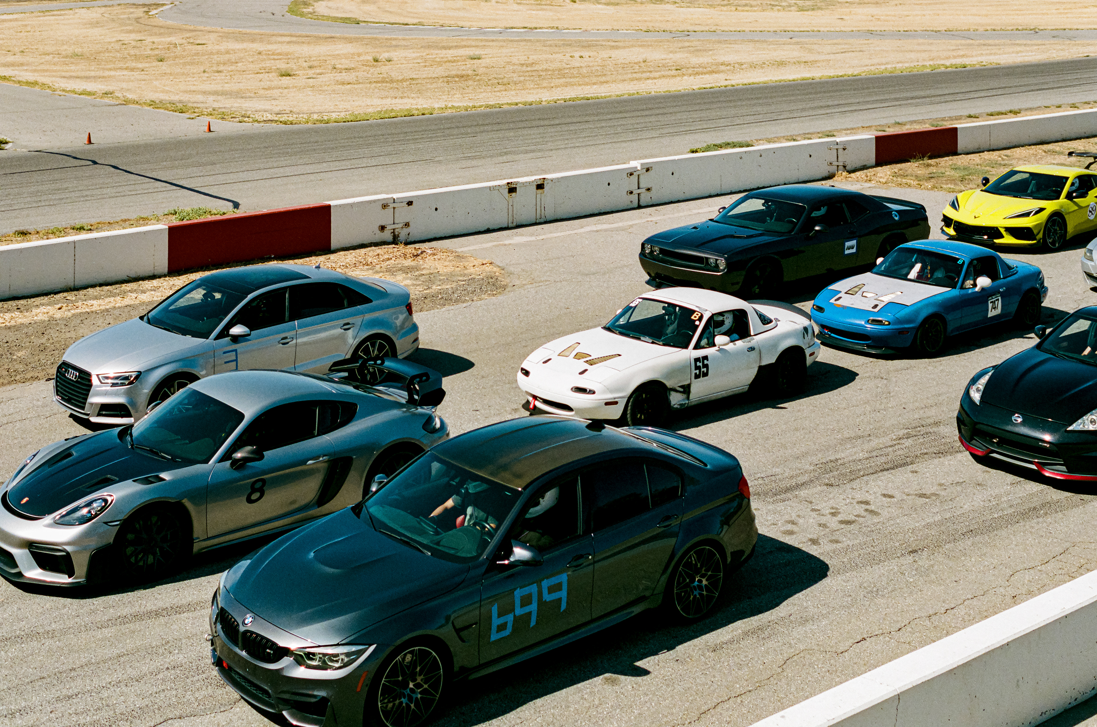 Line Up: Cars make ready for the first session of the day at Buttonwillow Raceway Park. Cyrus Legg spends the day practicing his performance driving skills in his Mazda Miata, named Kermit, at Button Willow Raceway Park  July 29, 2023 - Buttonwillow, CA - Photo by Aaron Guy Leroux