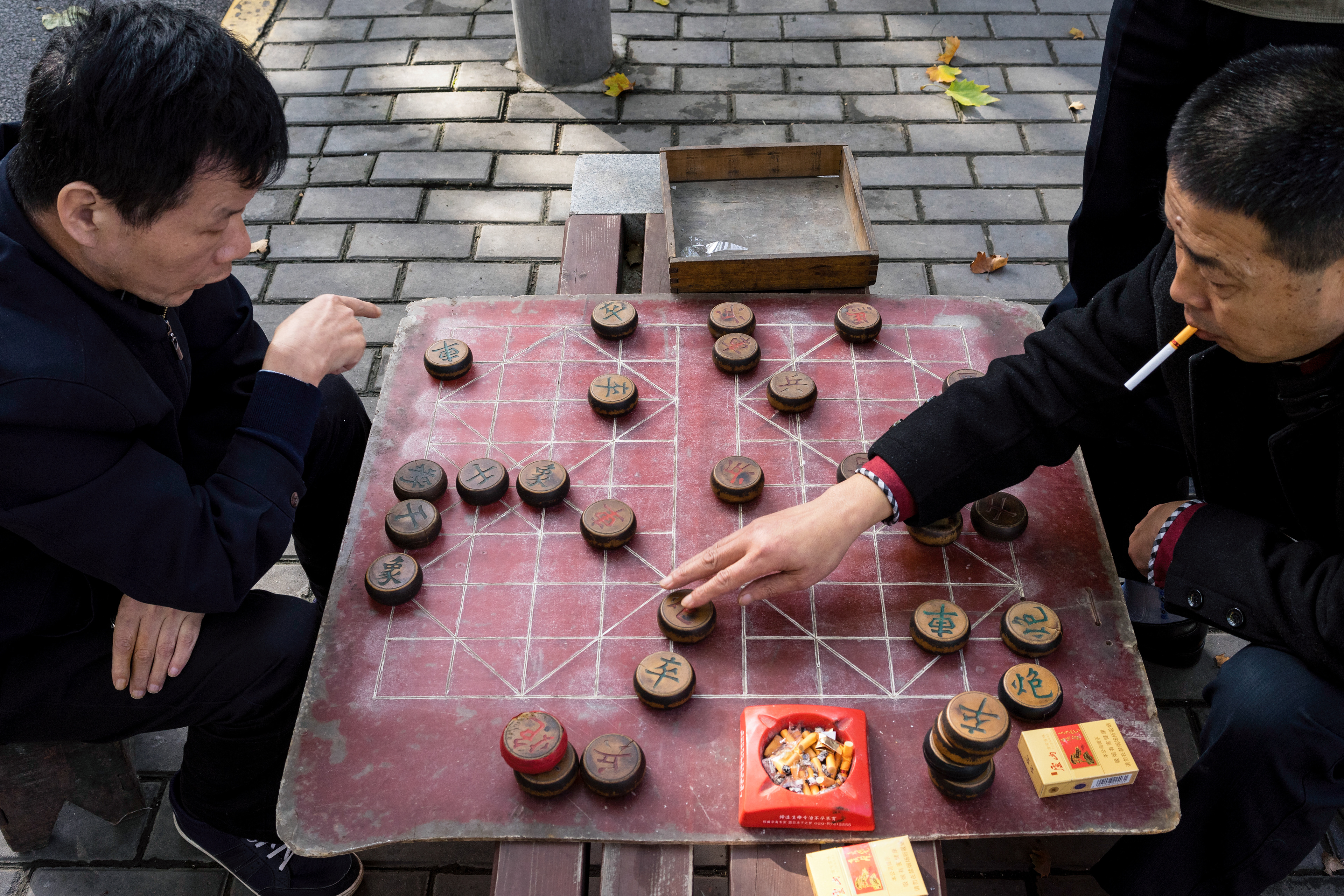 On nearly every corner, in almost any park, at any time of day one can find Chinese men playing chess,or cards, and smoking.
