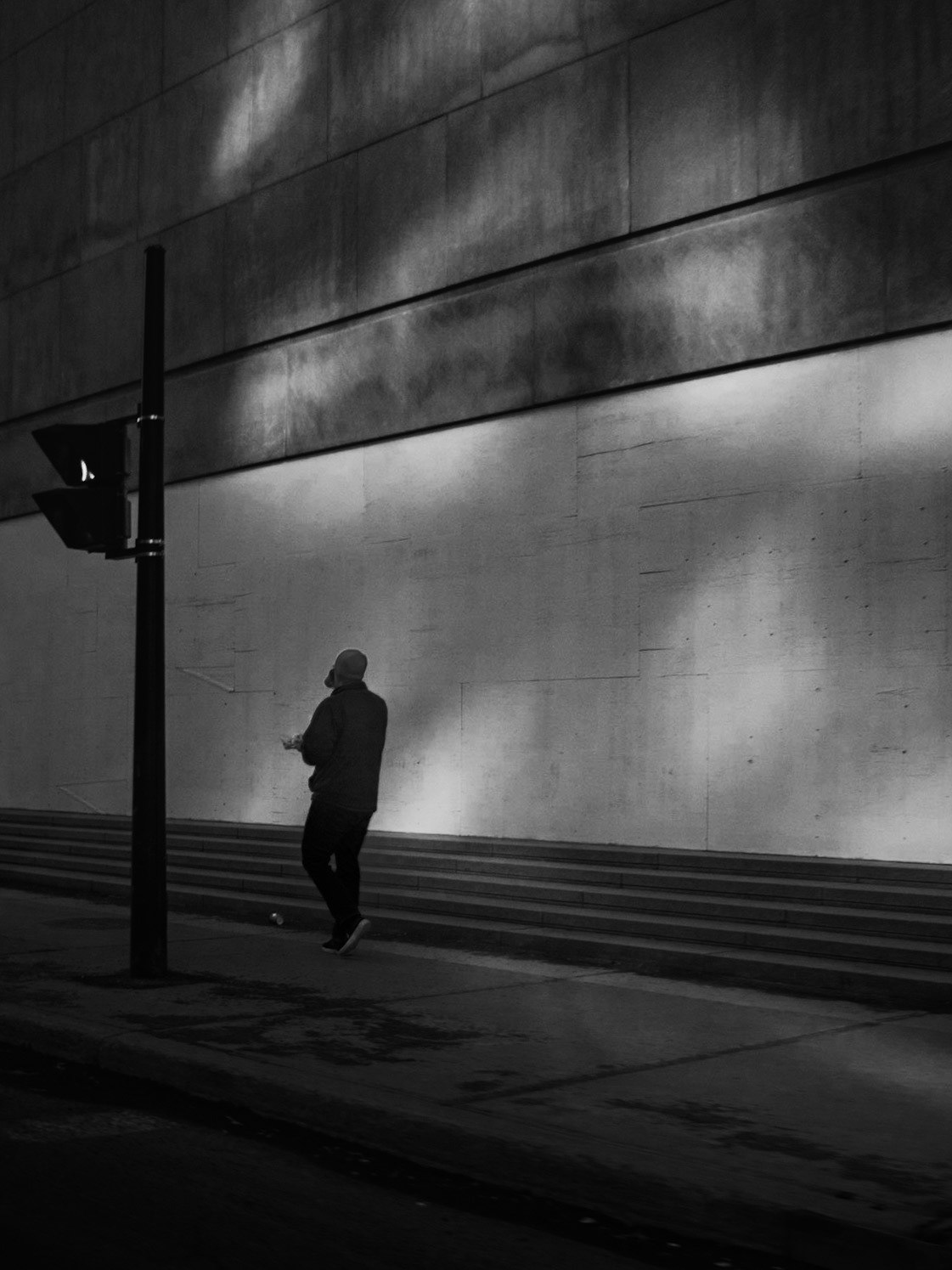 Montréal, 2020. A man walks by a boarded-up Place Ville-Marie Tower, during the Covid-19 pandemic.