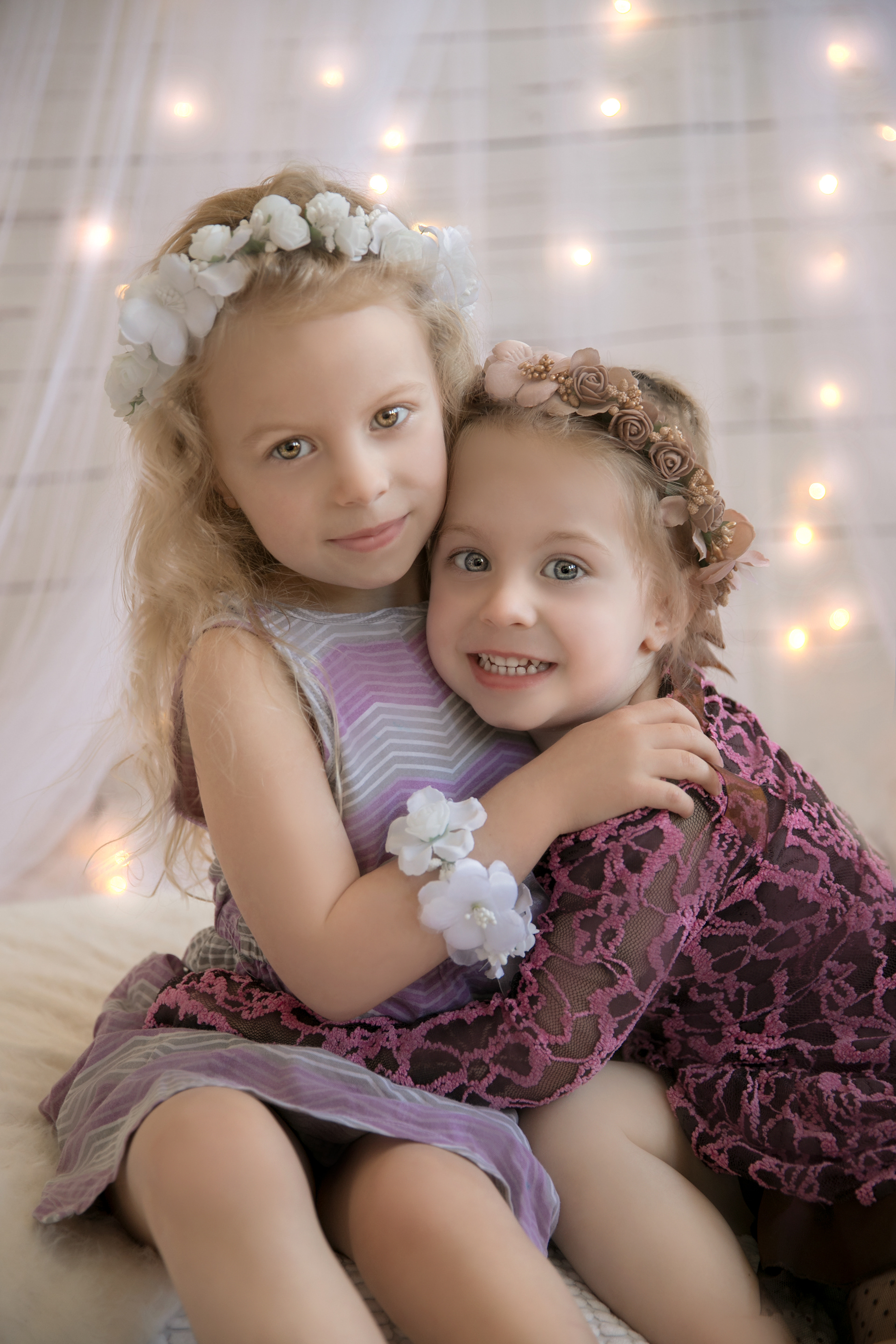 two little girls in pink dresses hugging