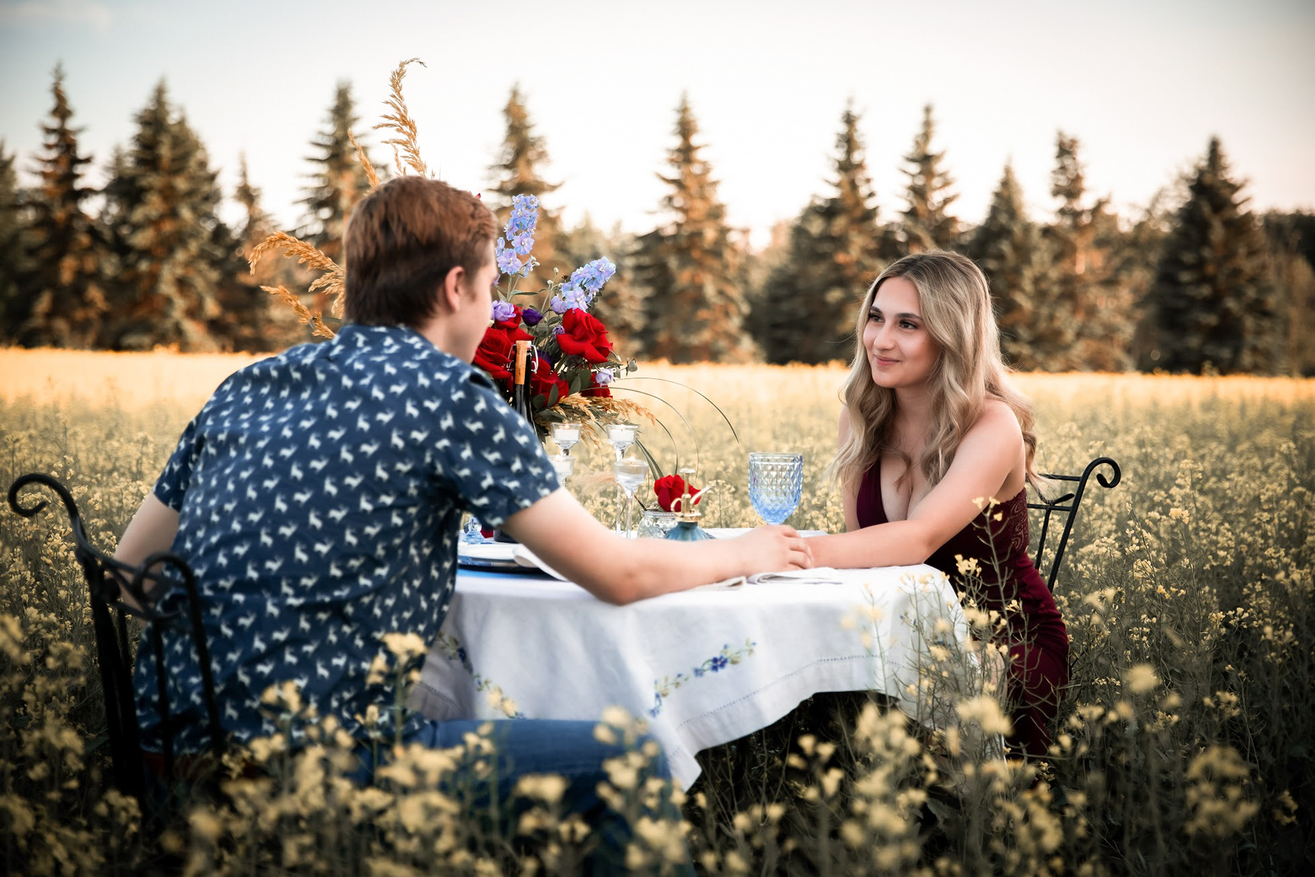 couple holding hands at the table 