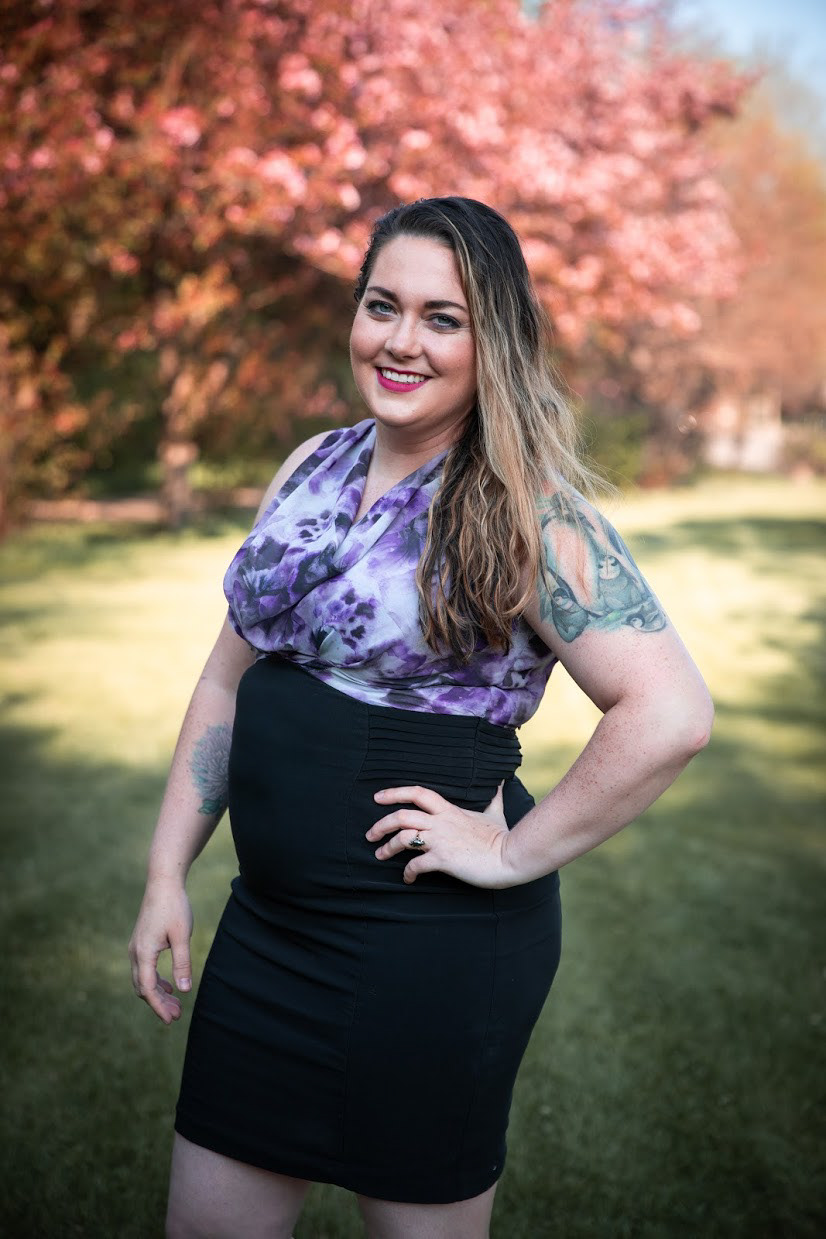 woman with hand on her hip smiling