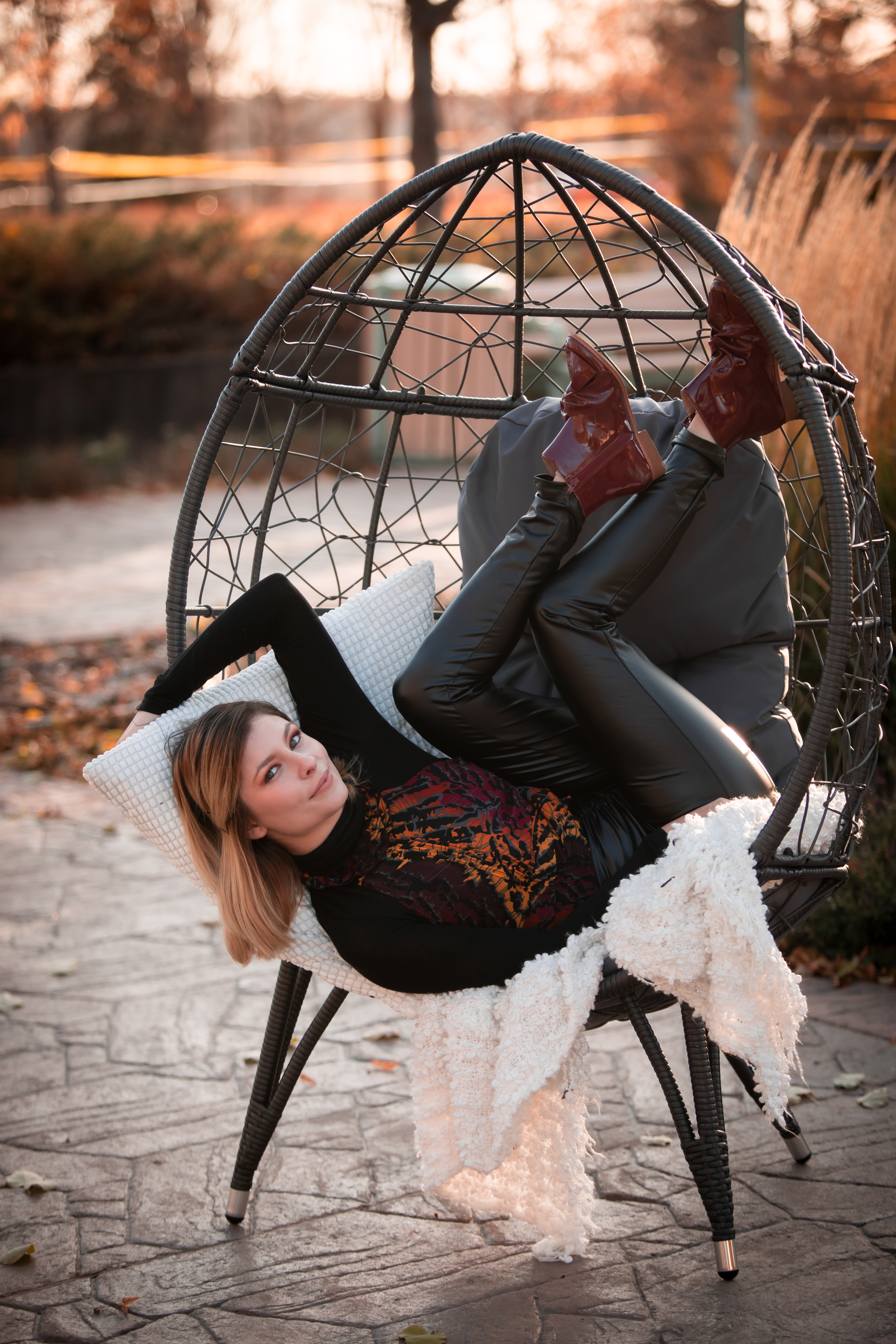 girl sitting upside down in egg chair