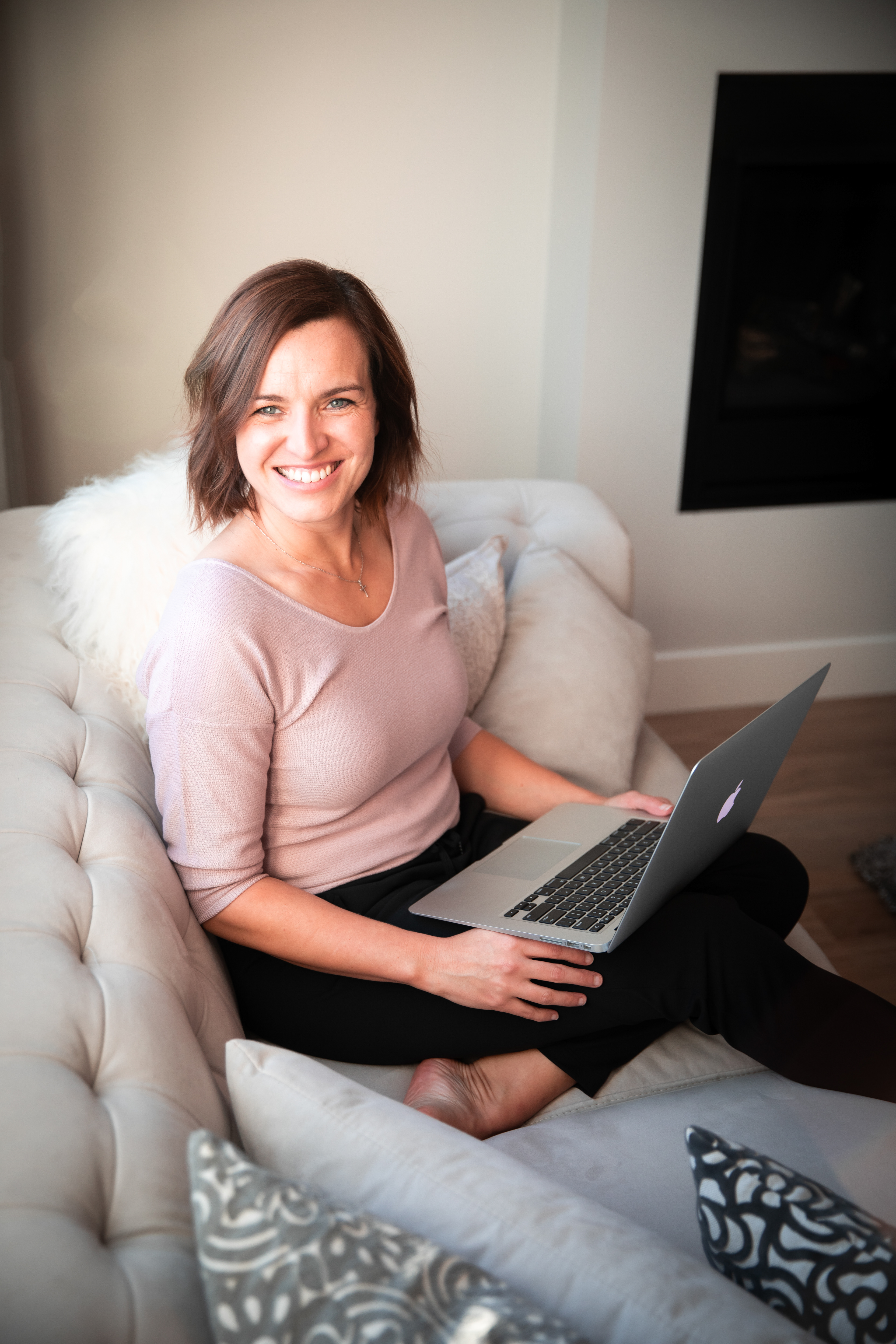 woman holding computer laughing