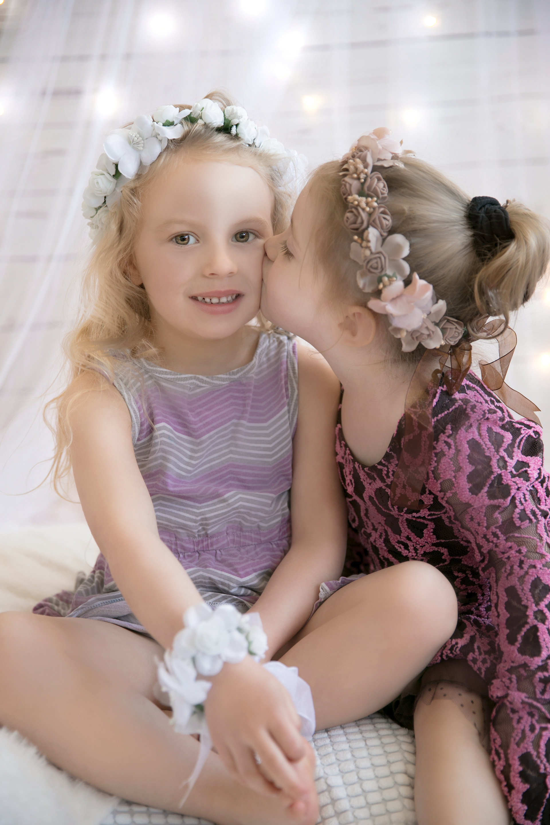 little girl getting a kiss from her baby sister
