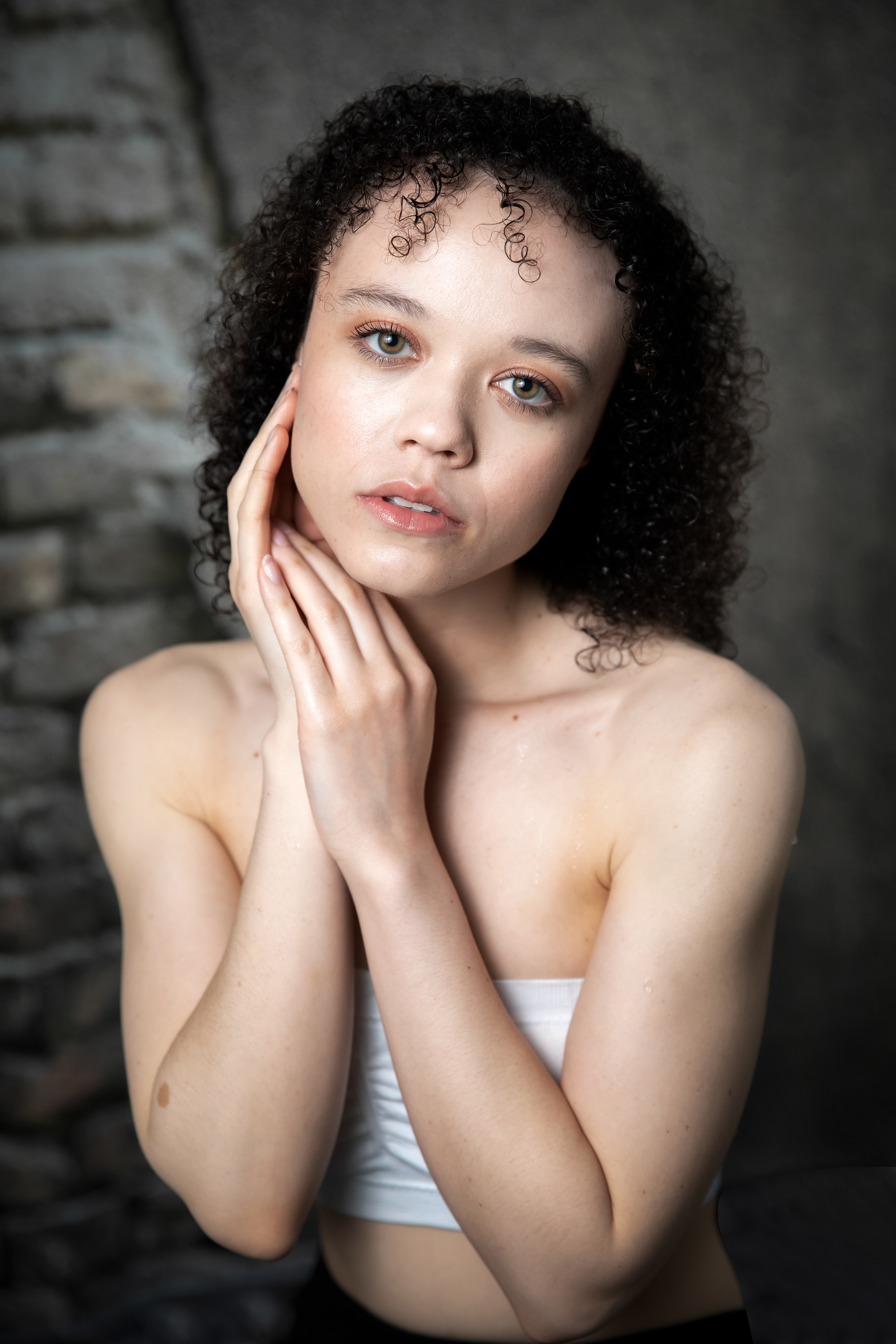 model holding her face