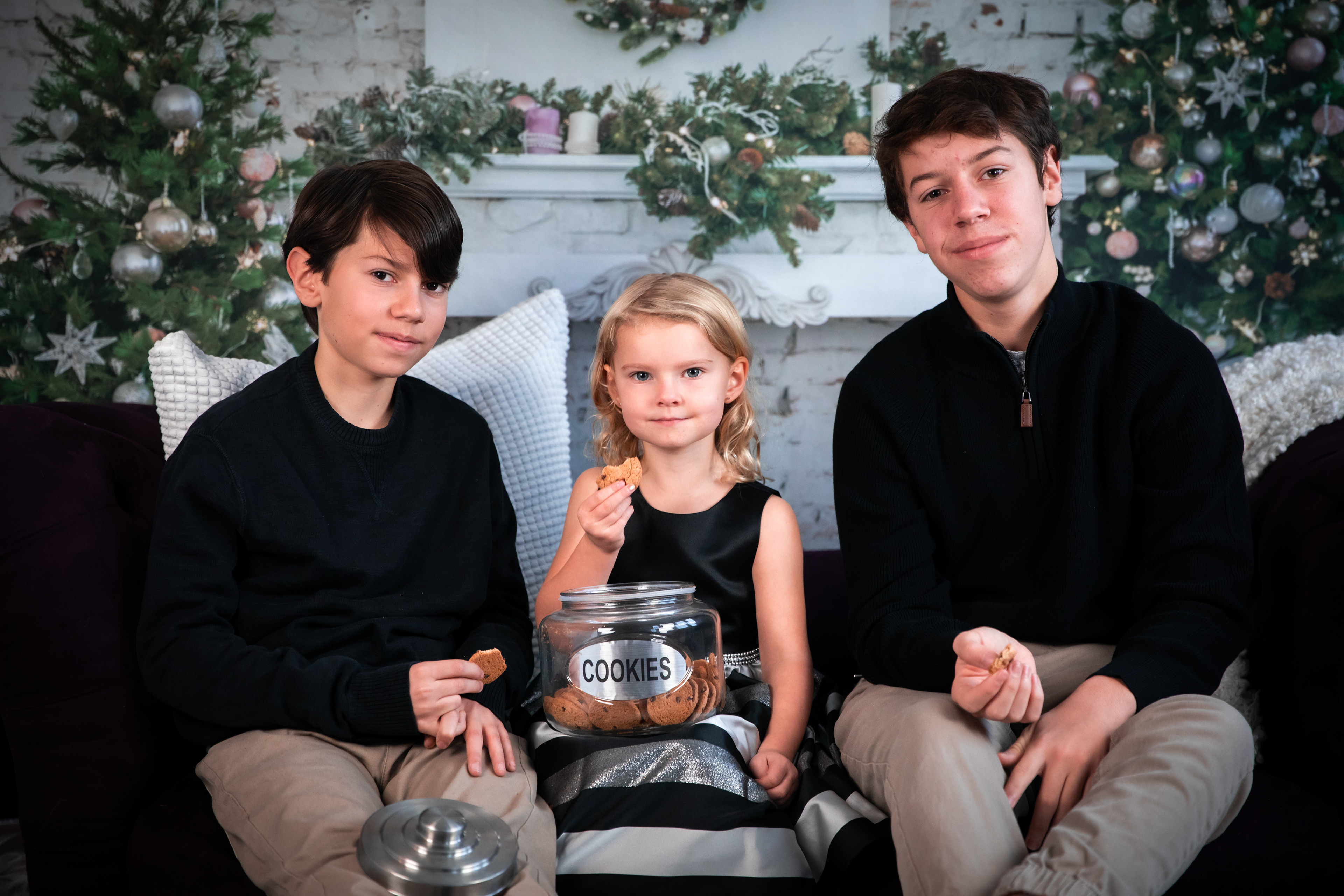 three little kids sharing cookies