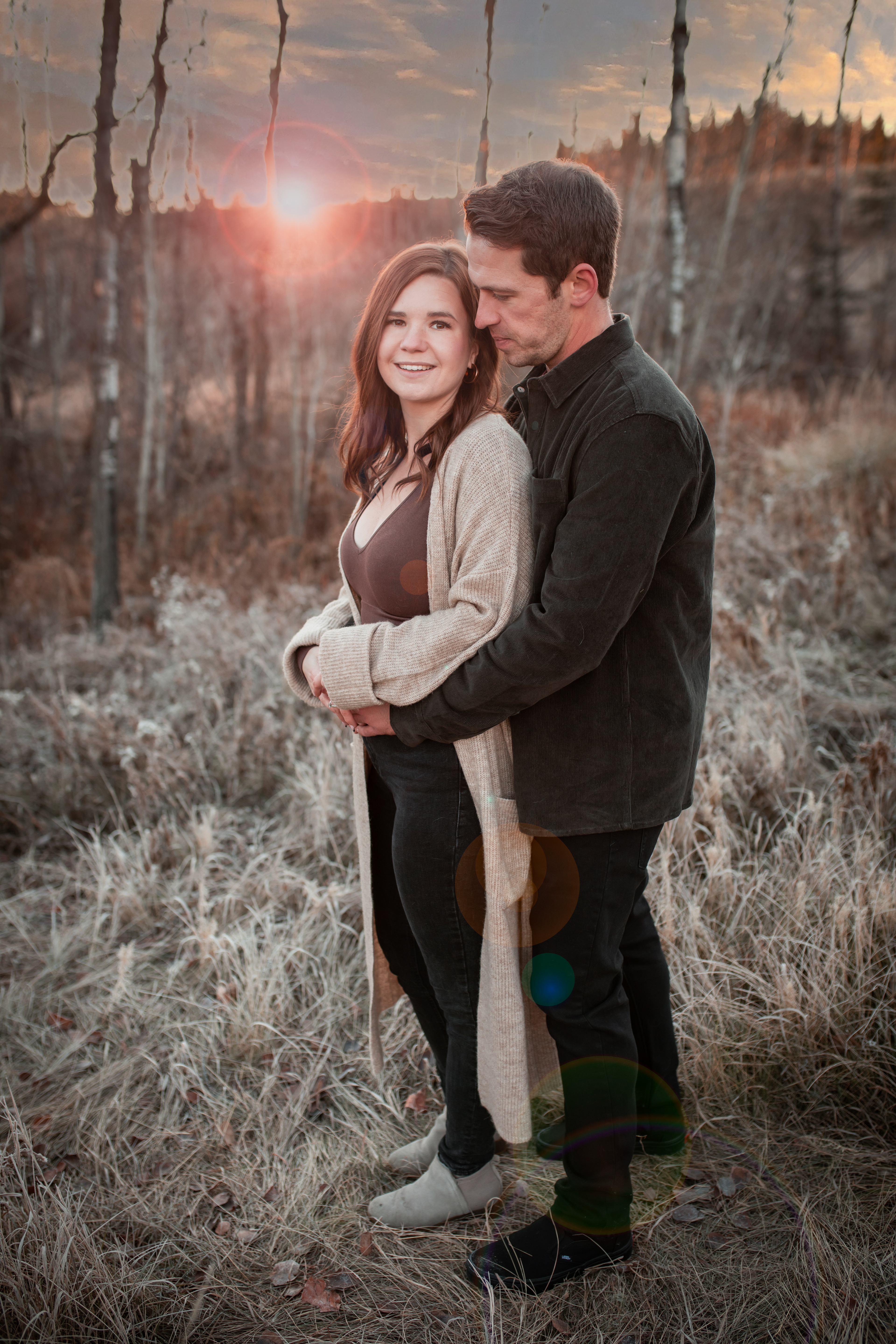 couple smiling and sun is coming up