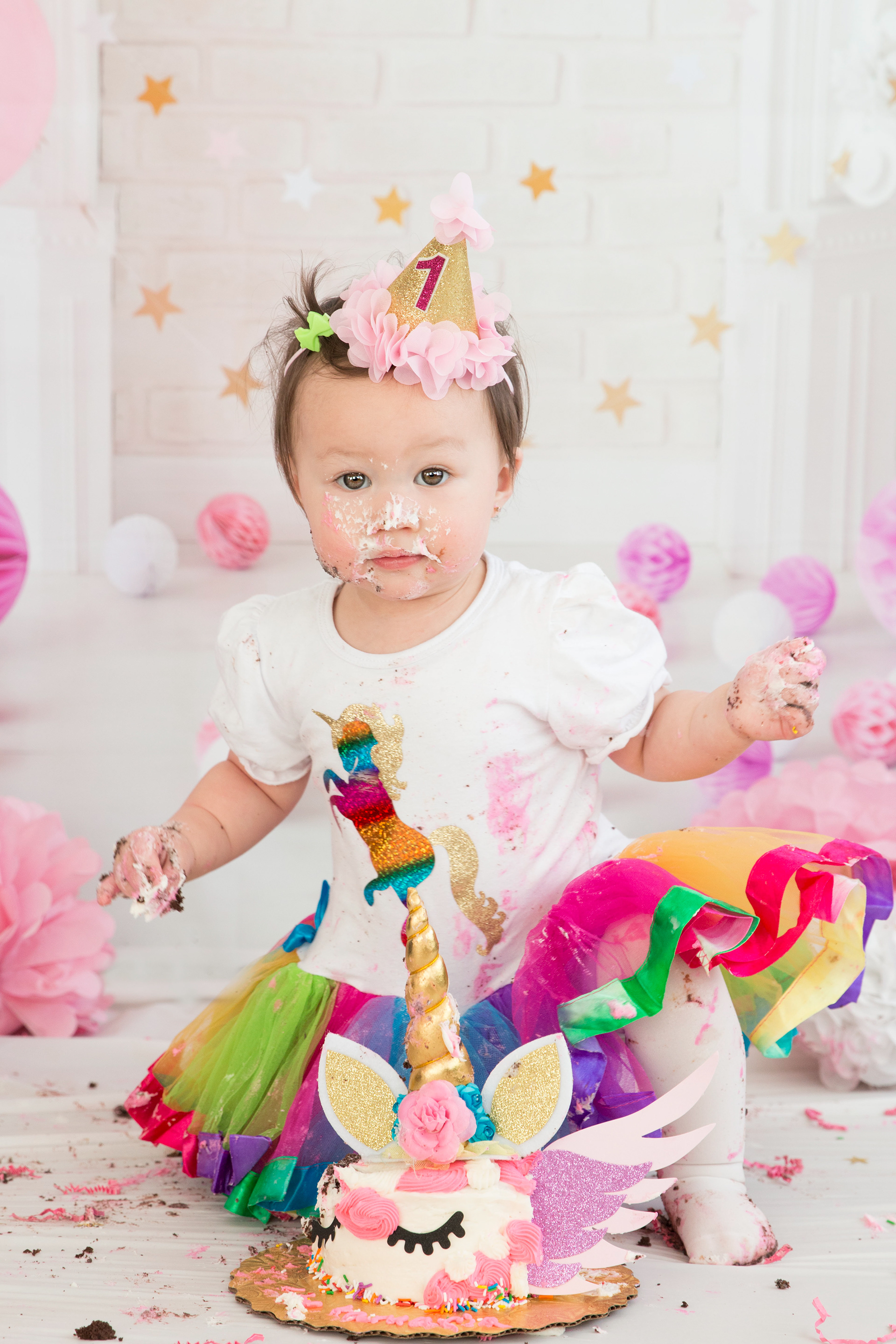 baby with cake all over her face