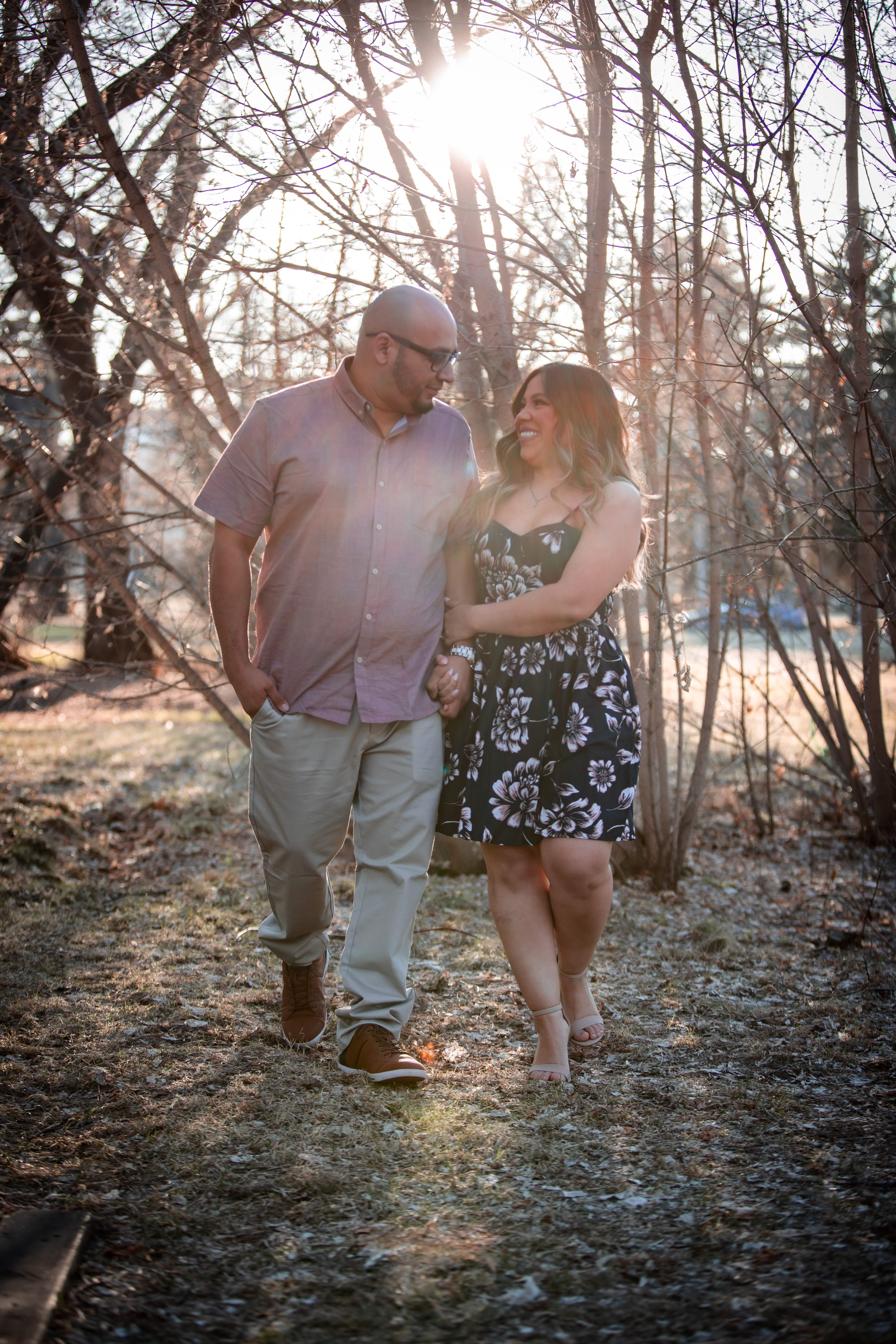 man and woman looking at each other laughing and walking