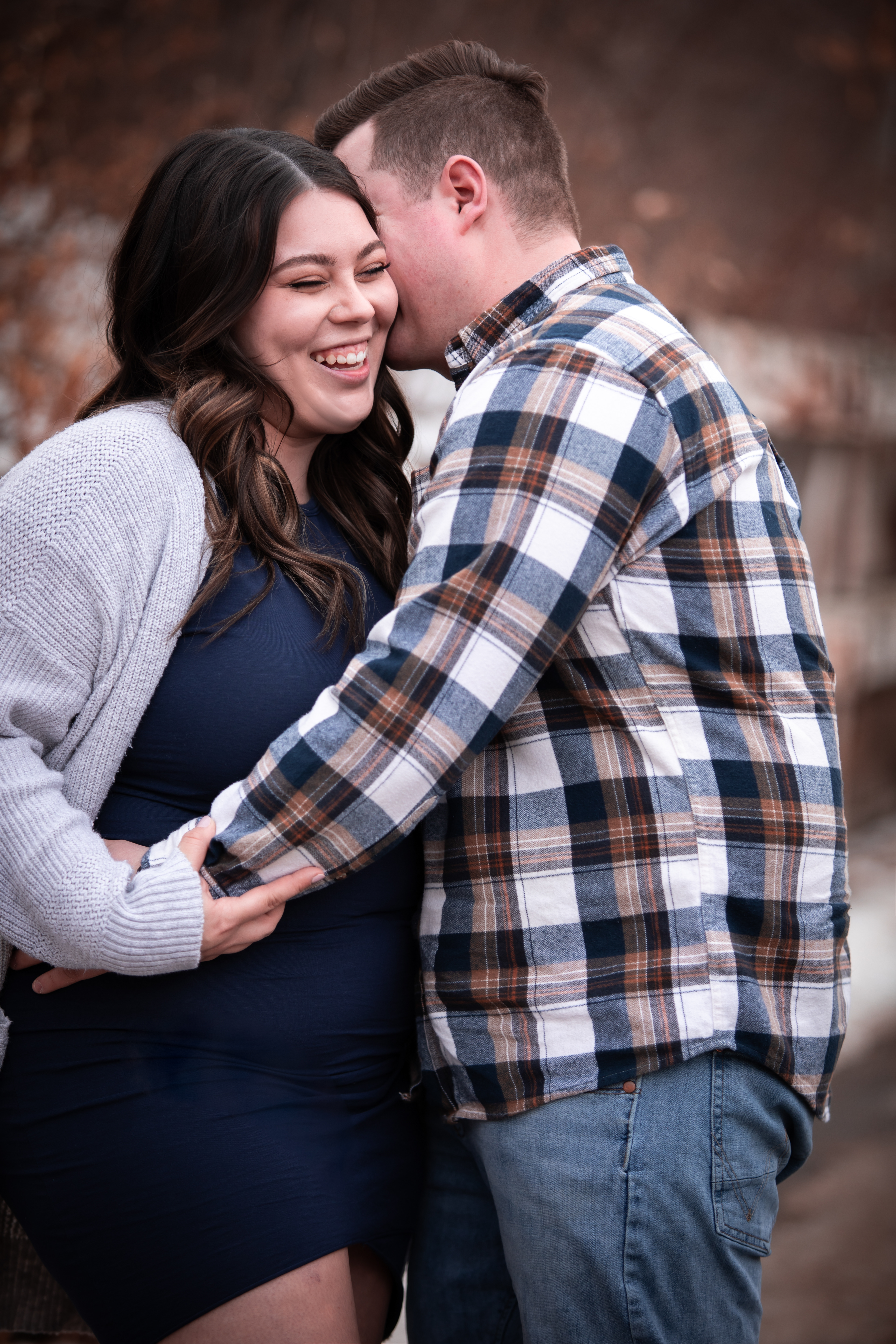 woman laughing and man whispering in her ear