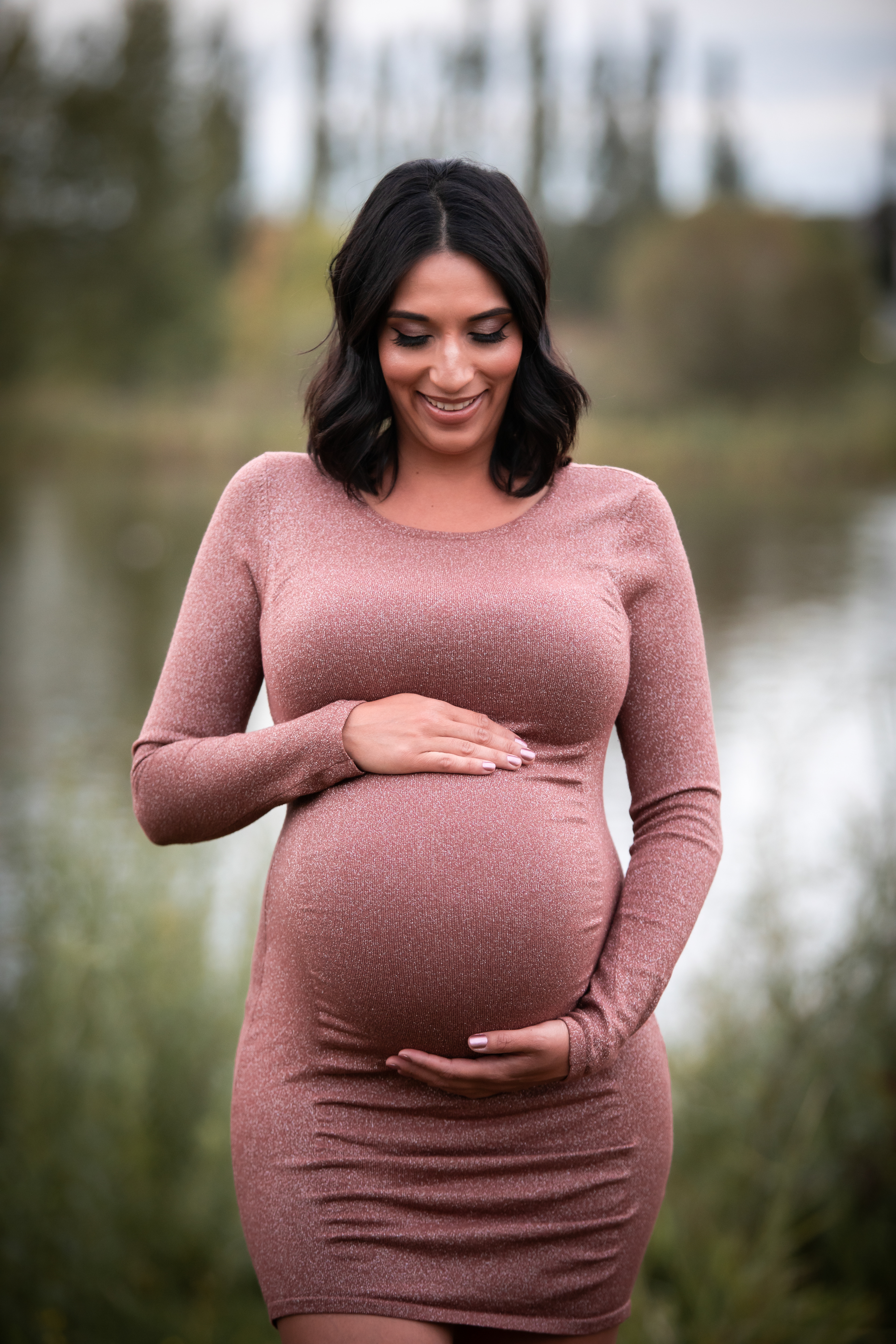 pregnant mom smiling at belly