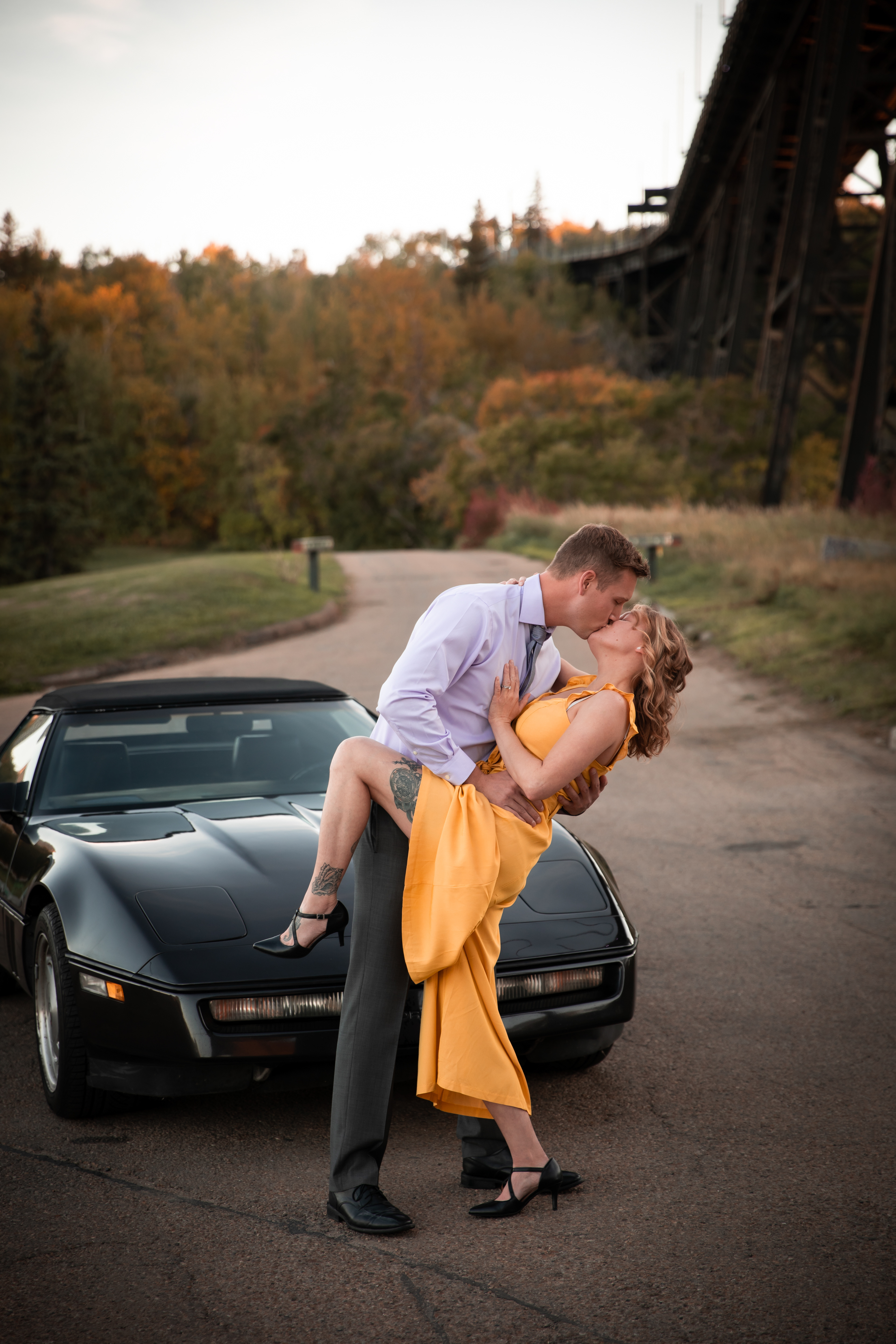 couple dipping in front of their car