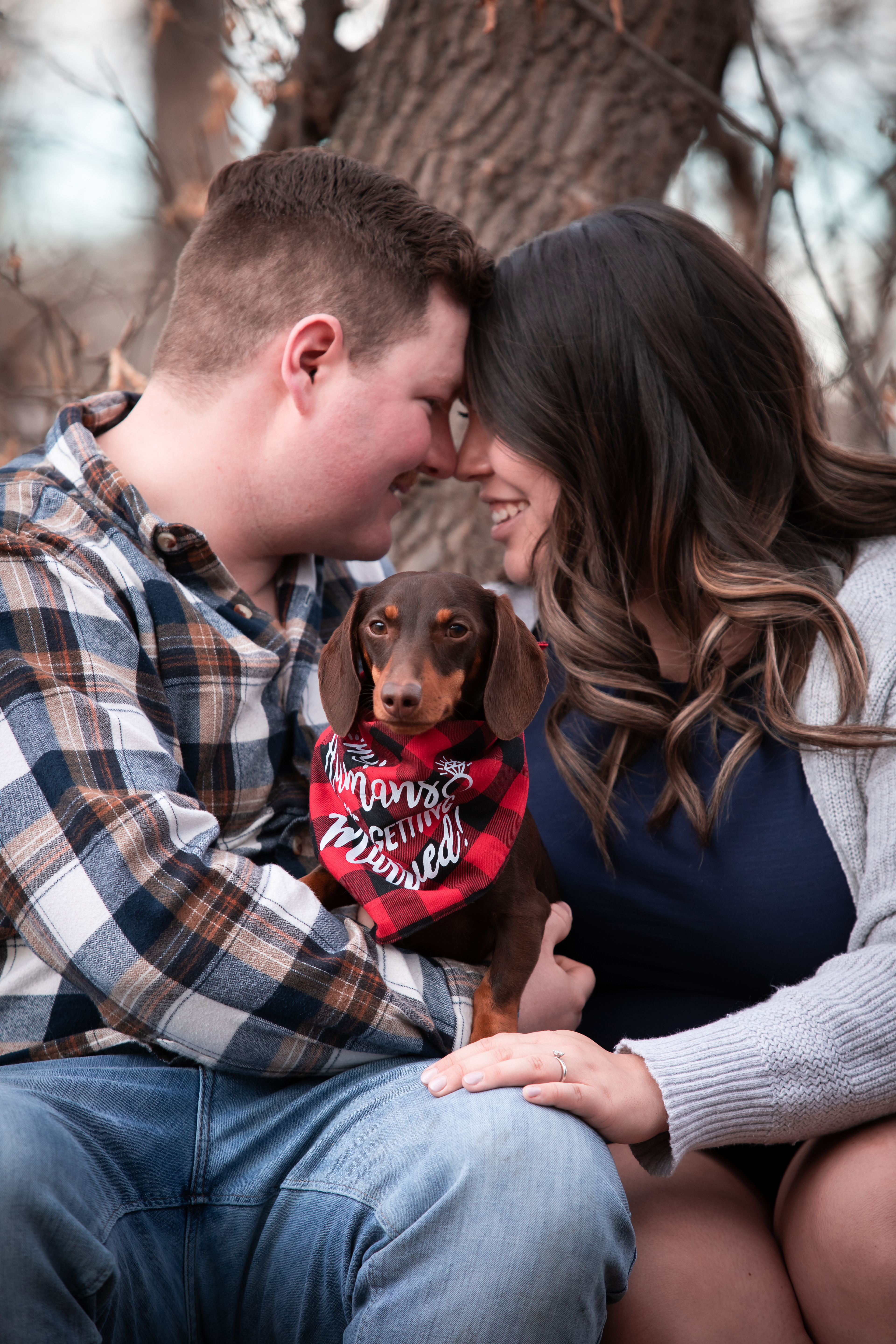 Man and woman holding dog laughing