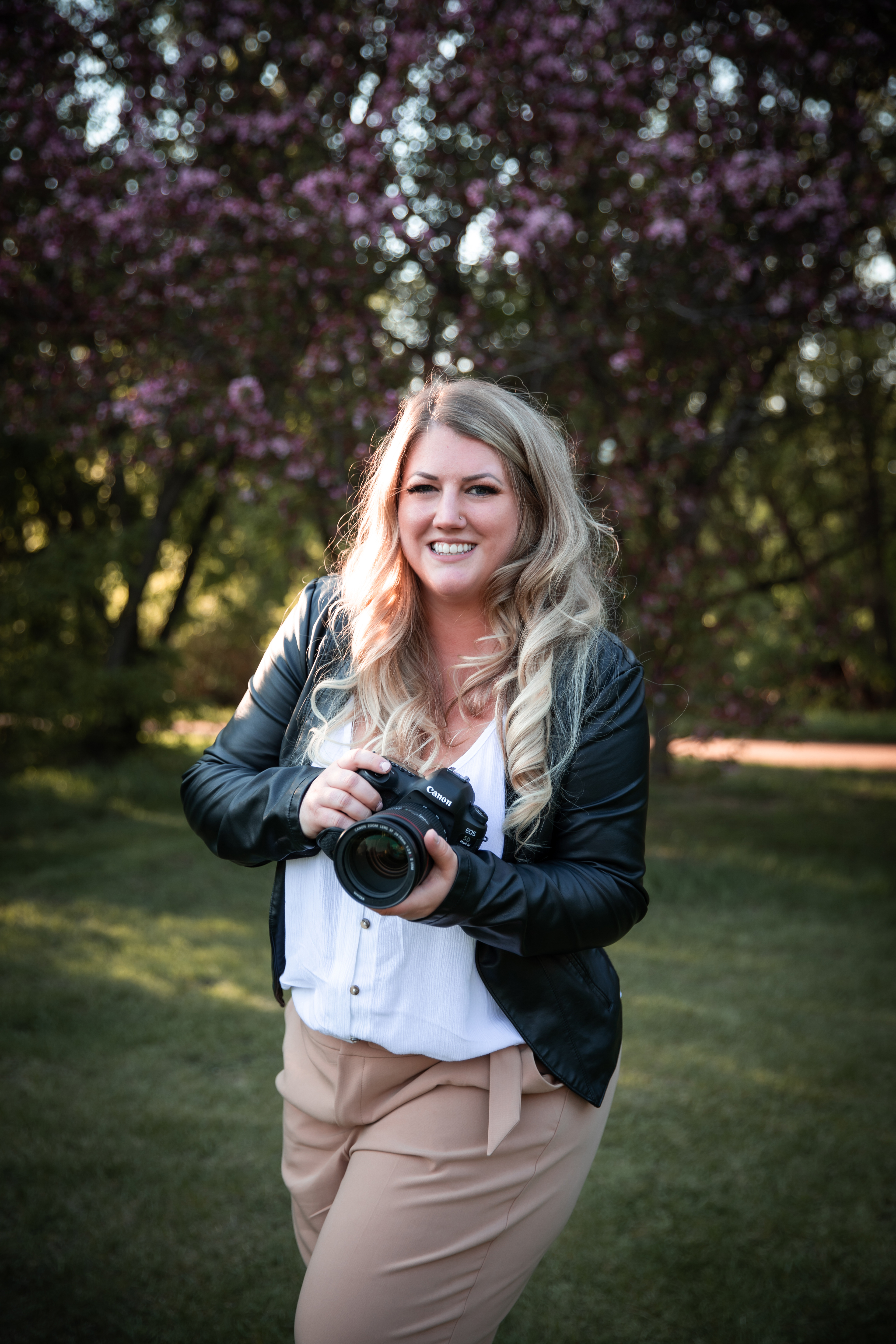 photographer holding camera laughing