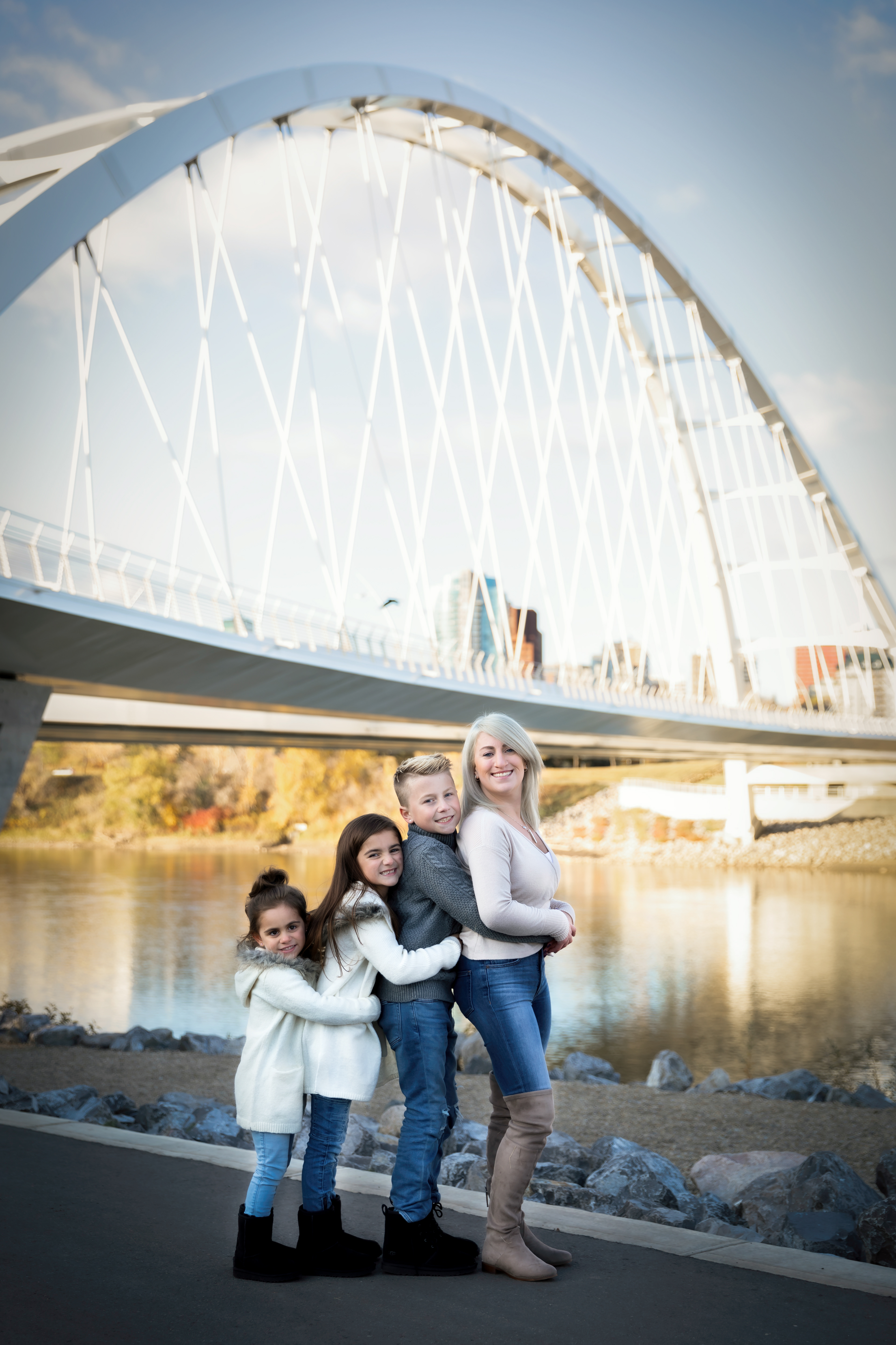 mom and kids standing by the bridge