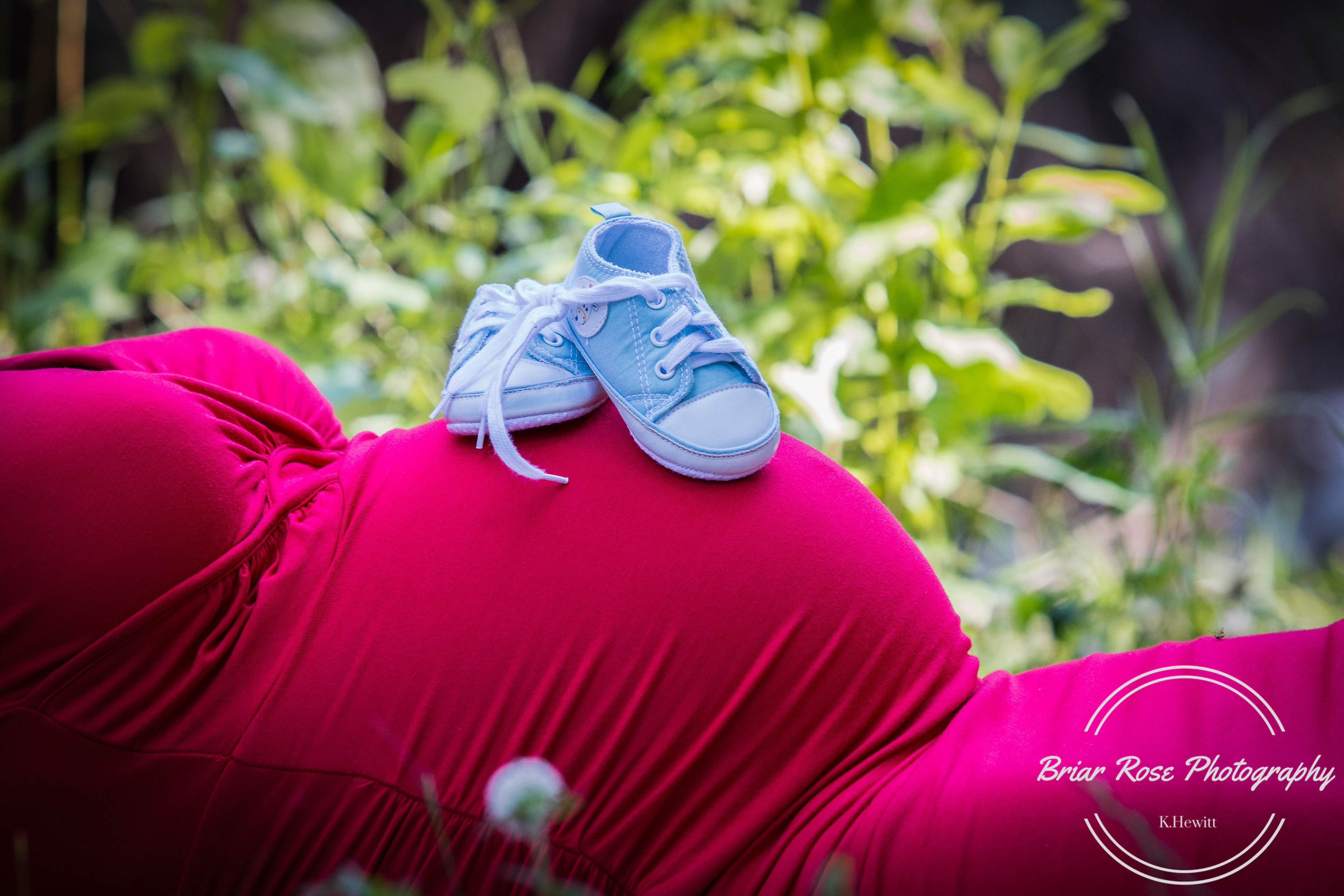 mom with baby shoes on tummy