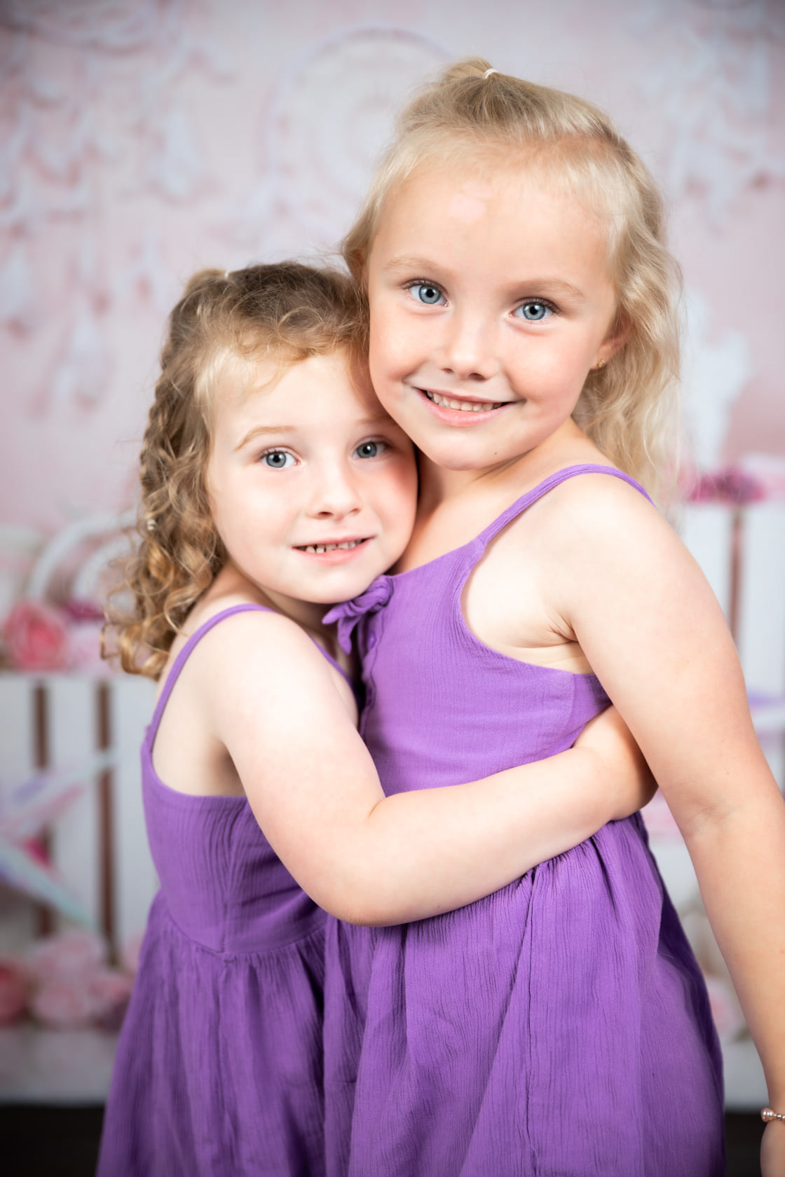 two sisters hugging each other 