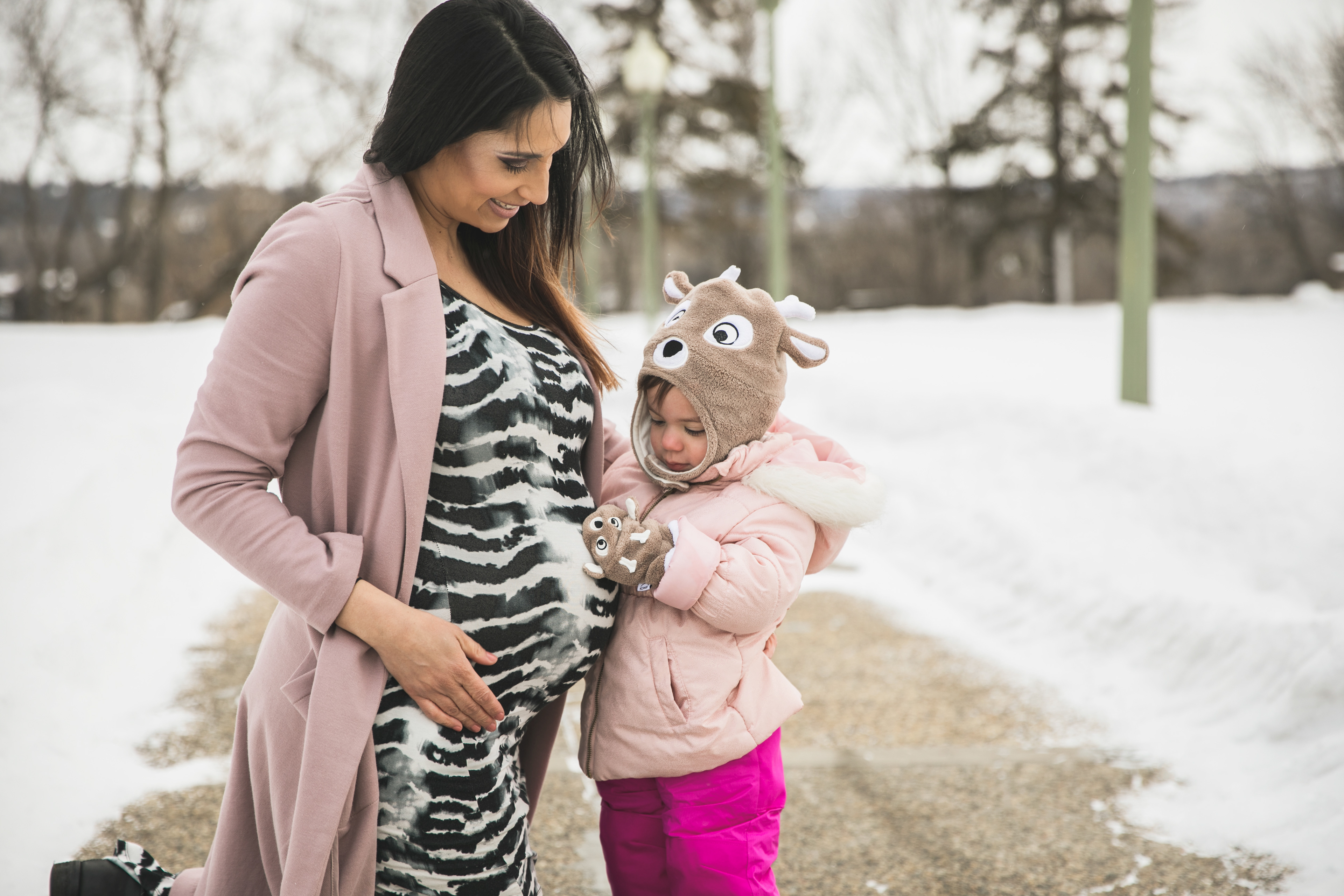 mom and daughter looking at baby in her tummy