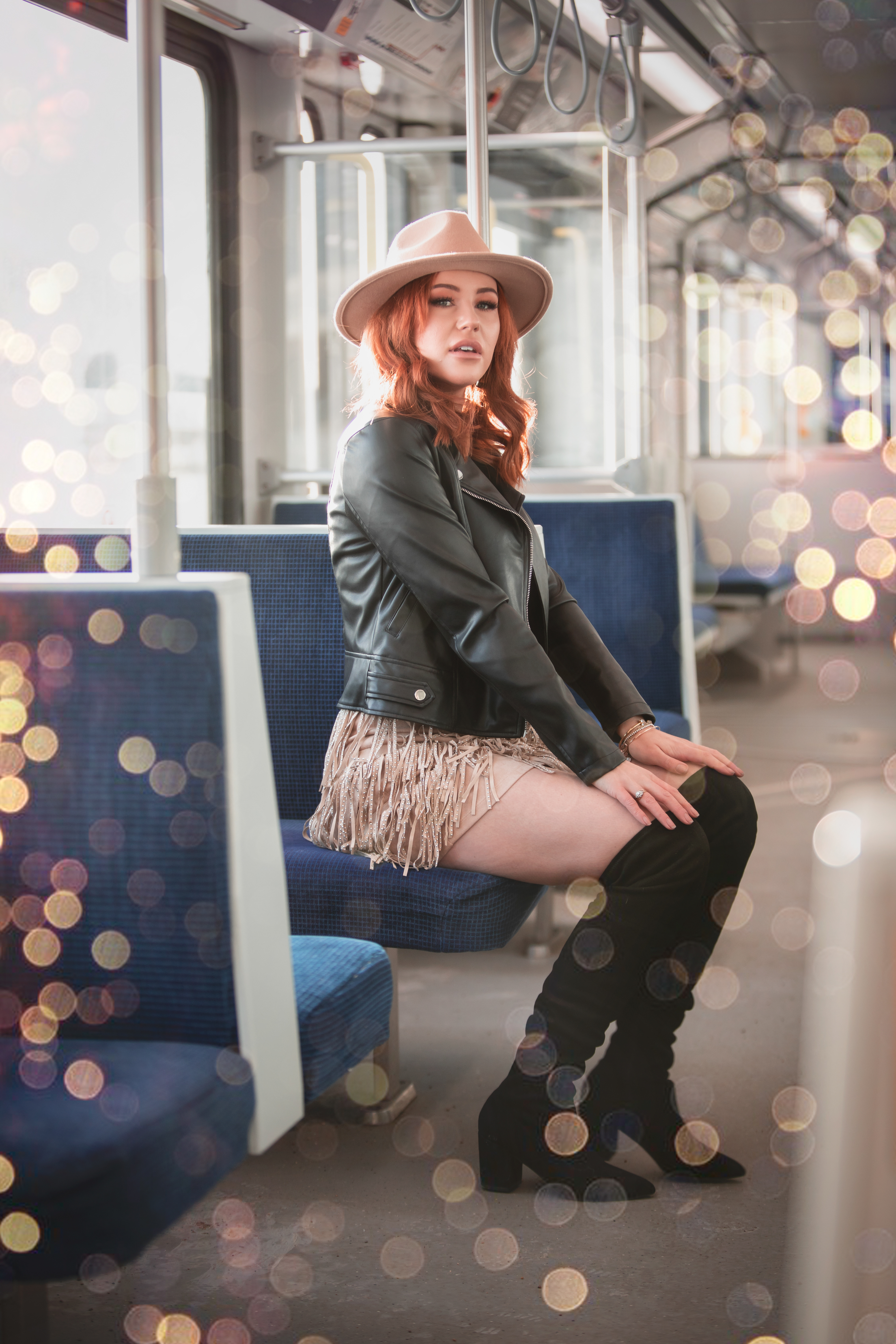 model sitting on the LRT