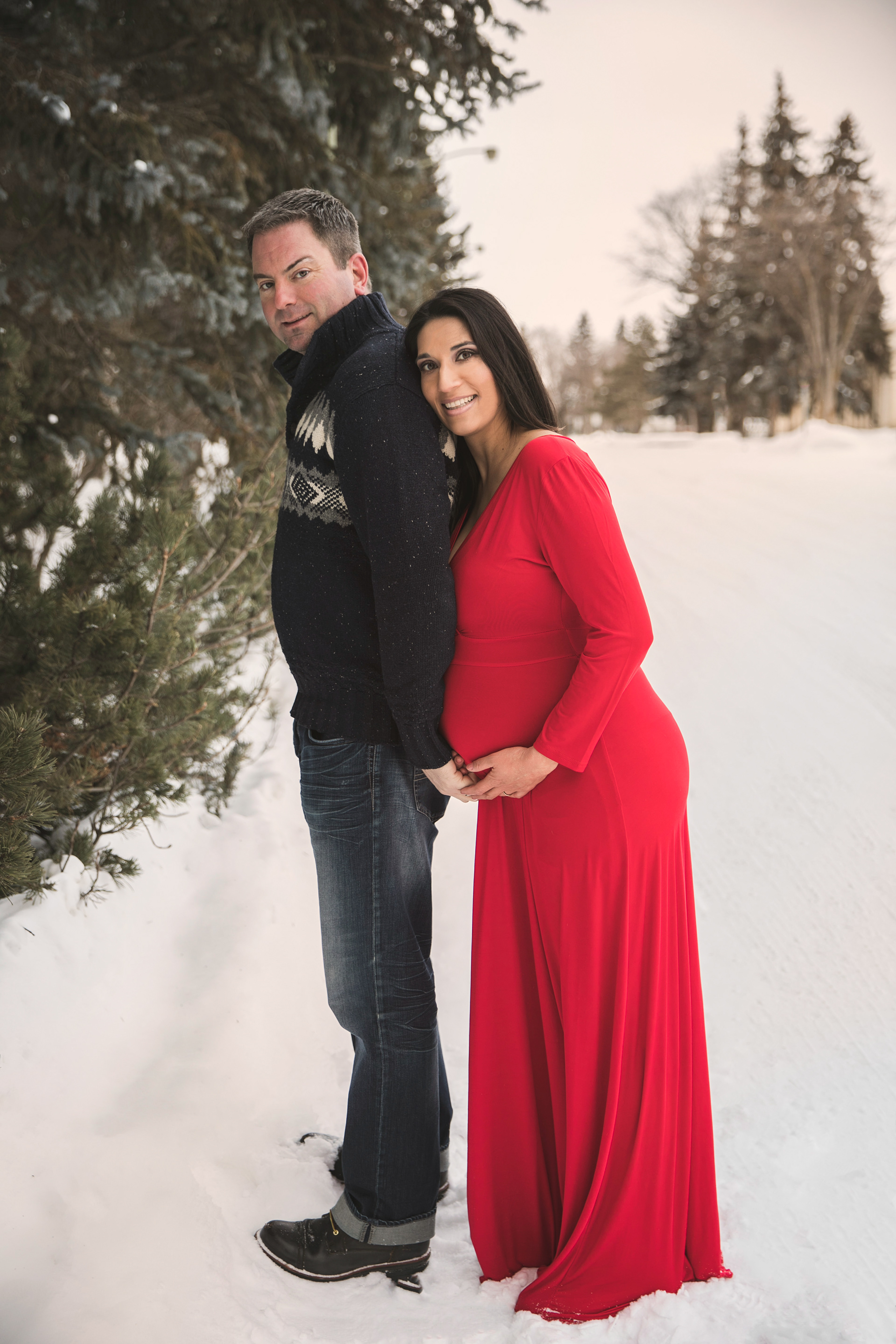 dad holding moms baby bump