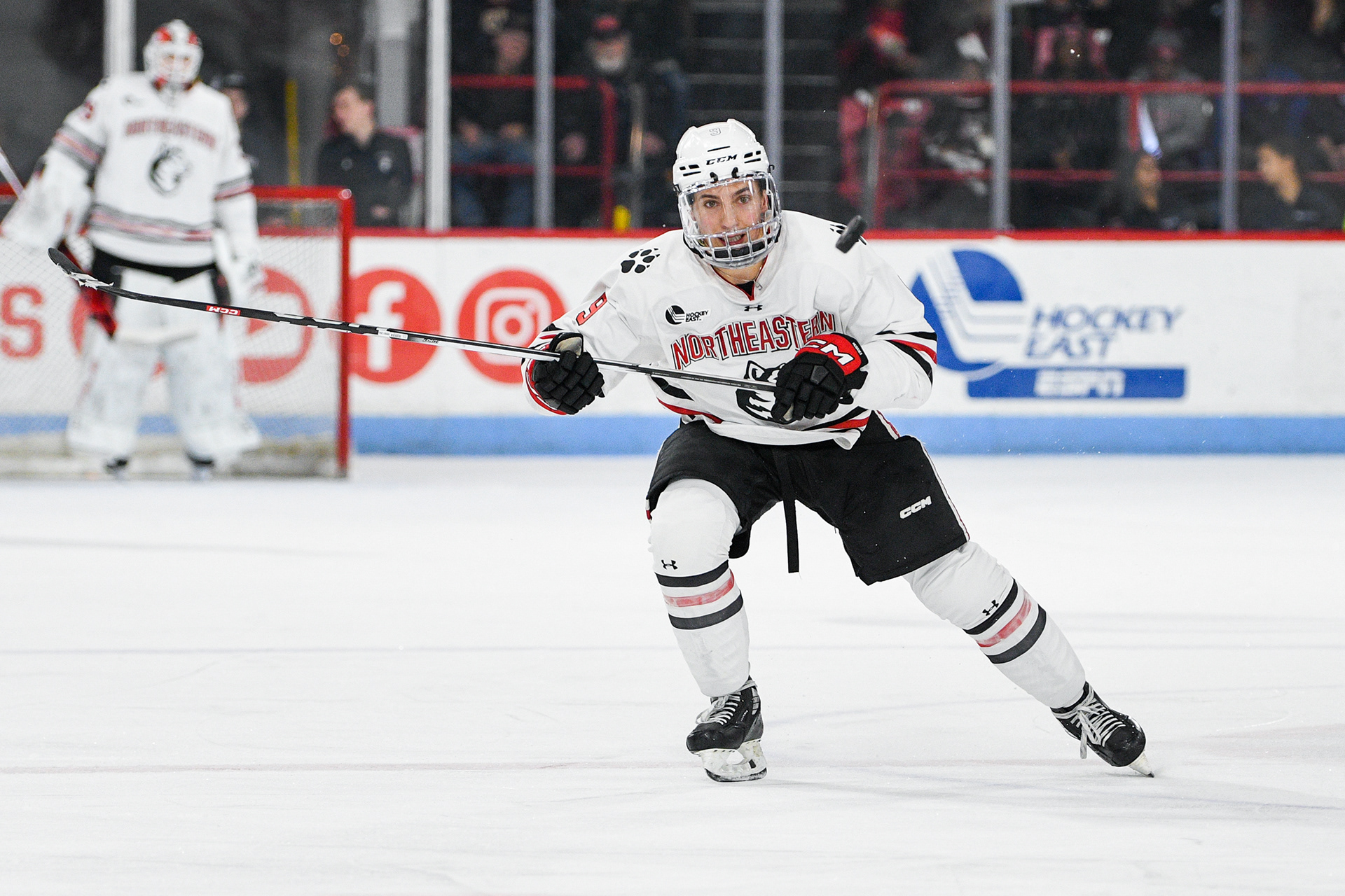 Matt Choupani (NU) staring at the puck lifted off the ice at the game against BC at Matthews Arena, December 02, 2023
