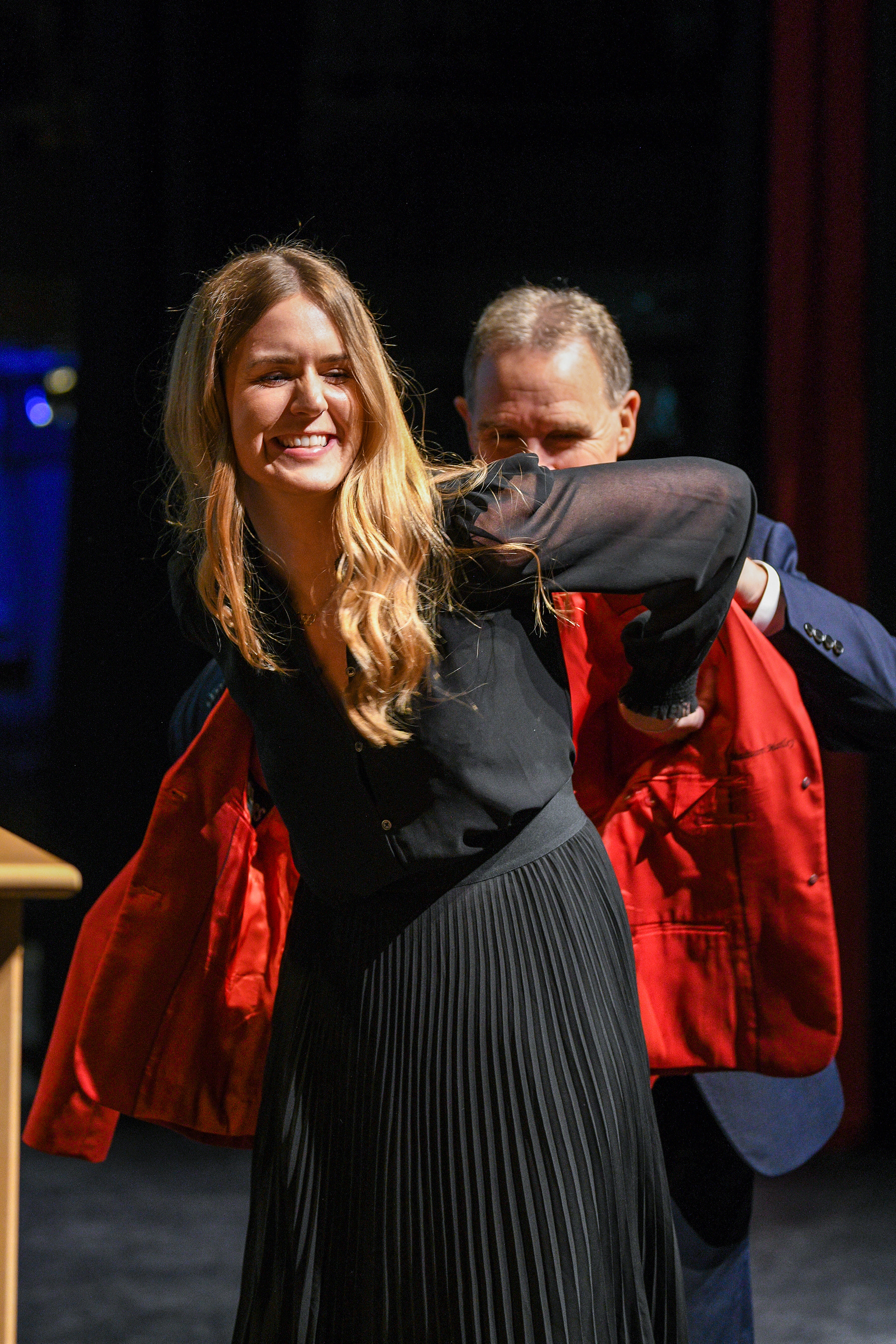 Madison Mailey receiving her idnuctee jacket from Jim Madigan