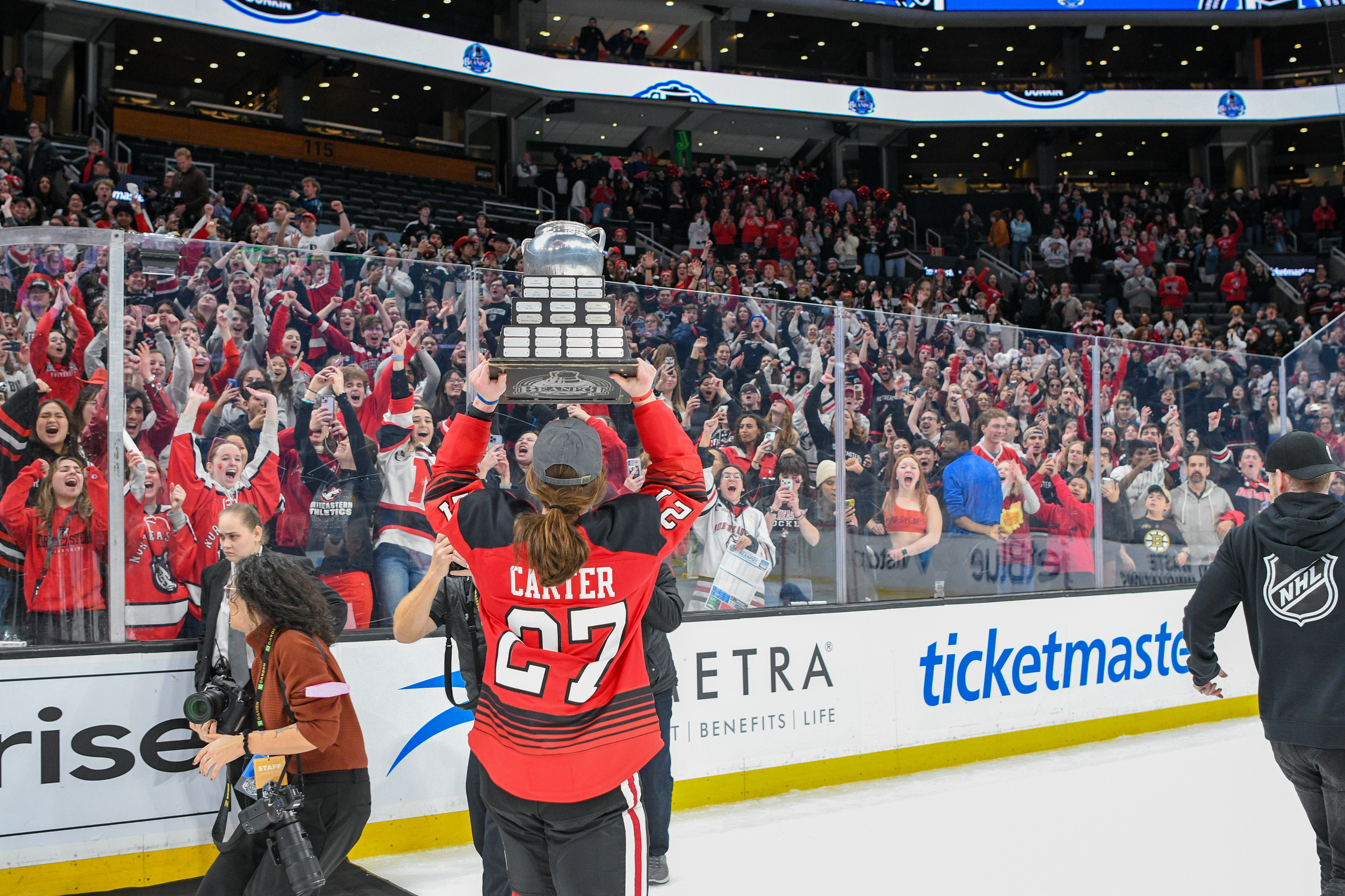 Meghan Carter showing off the trophy to NU fans.