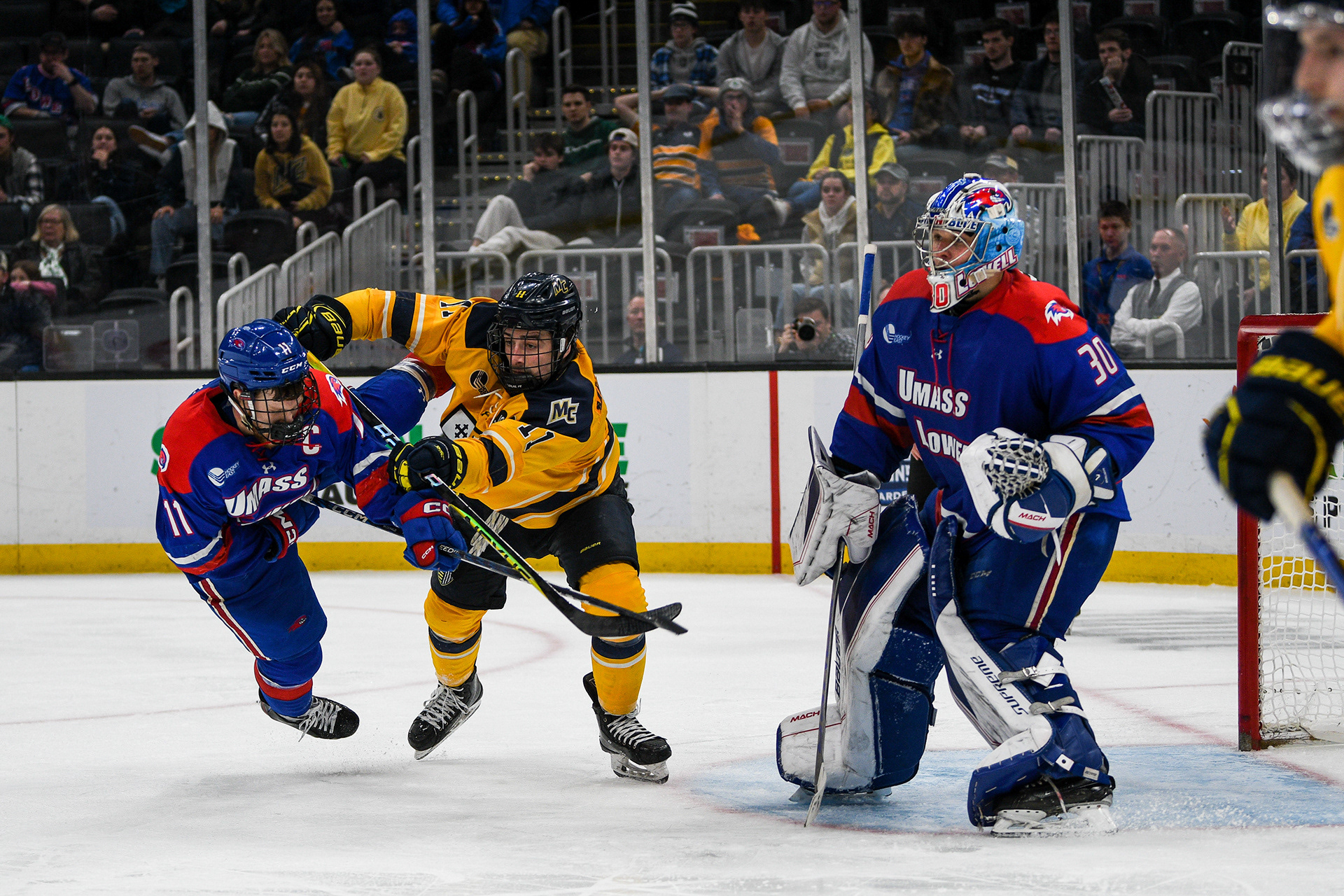 Merrimack College forward Nick Messner defending his spot in front of UMass Lowell goalie Gustavs-Davis Grigals.