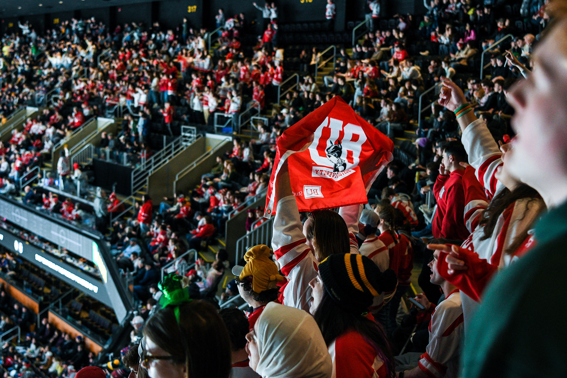 BU Fans waving a Terriers flag as the team scores the game-tying point.