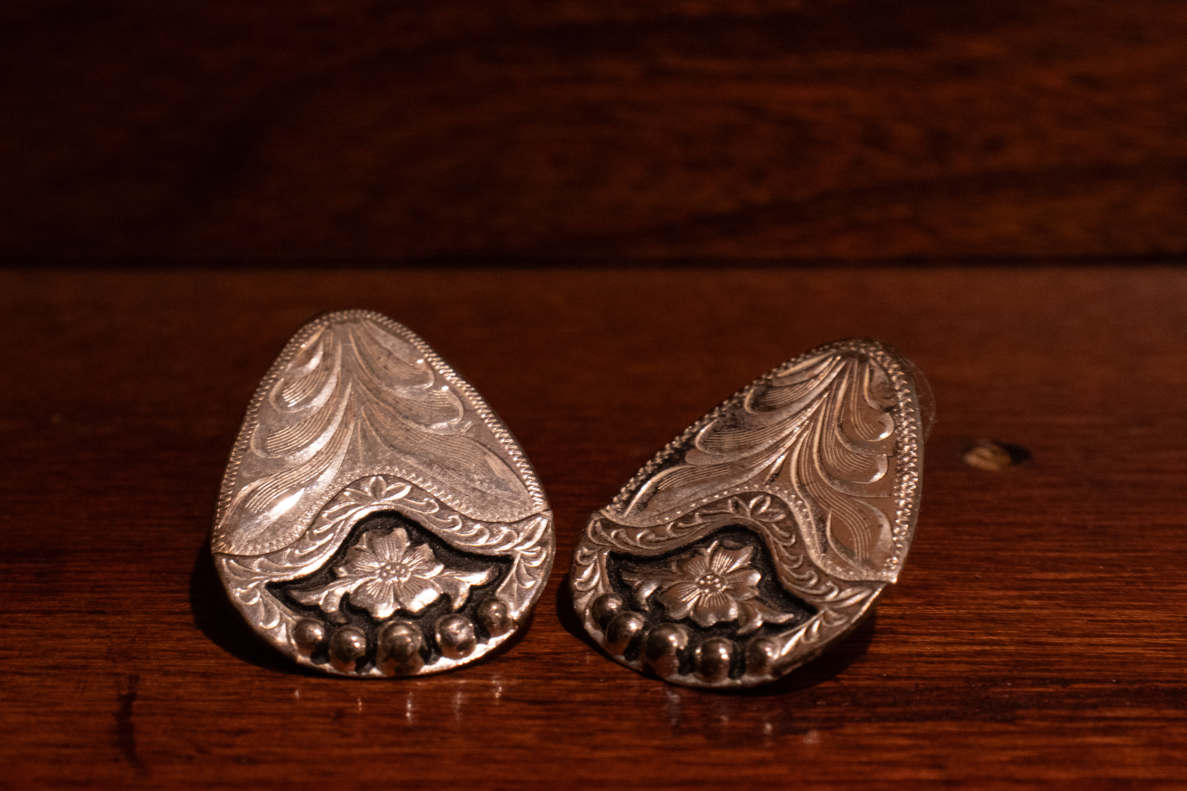 Earrings from my grandma's jewelry box placed on my piano for a wooden background.