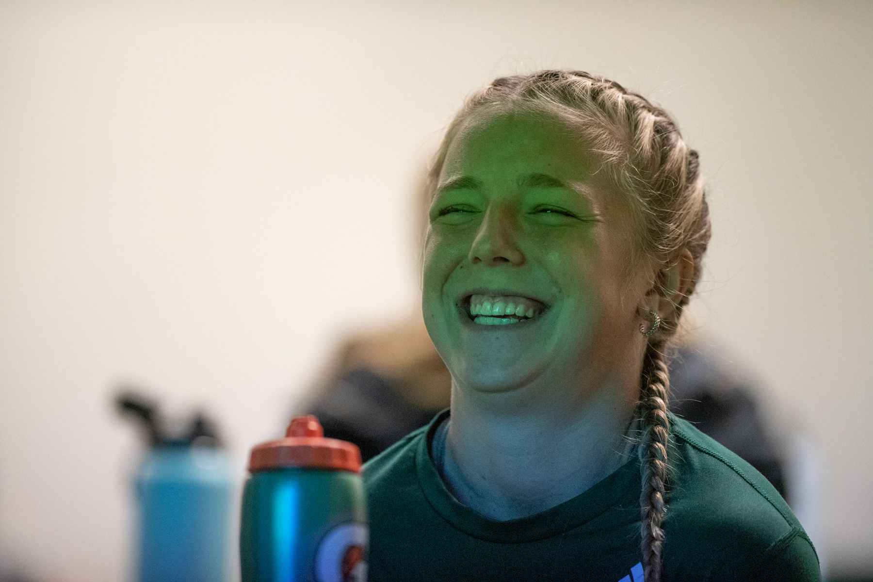 Kennedy Rieple laughs while watching a presentation put on by Head Coach Aaron Rodgers before their game against Western Michigan in Athens, Ohio, on Sunday, Oct. 23, 2022. At the end of each presentation Rodgers plays a montage of replays with a clever song played over them.