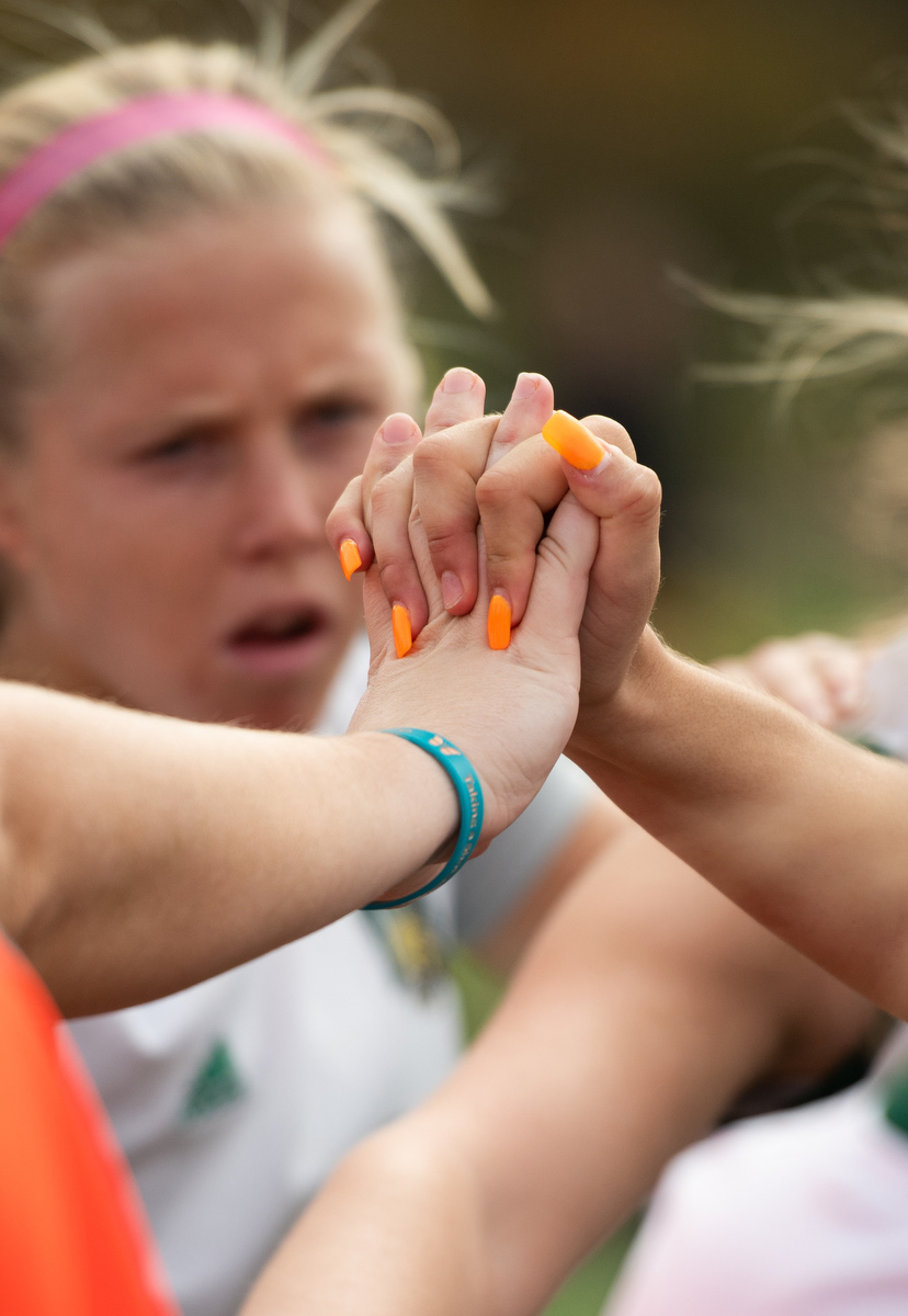 Shae Robertson holds a teammate’s hand before their game against Ball State in Athens, Ohio, on Sunday, Oct. 16, 2022.