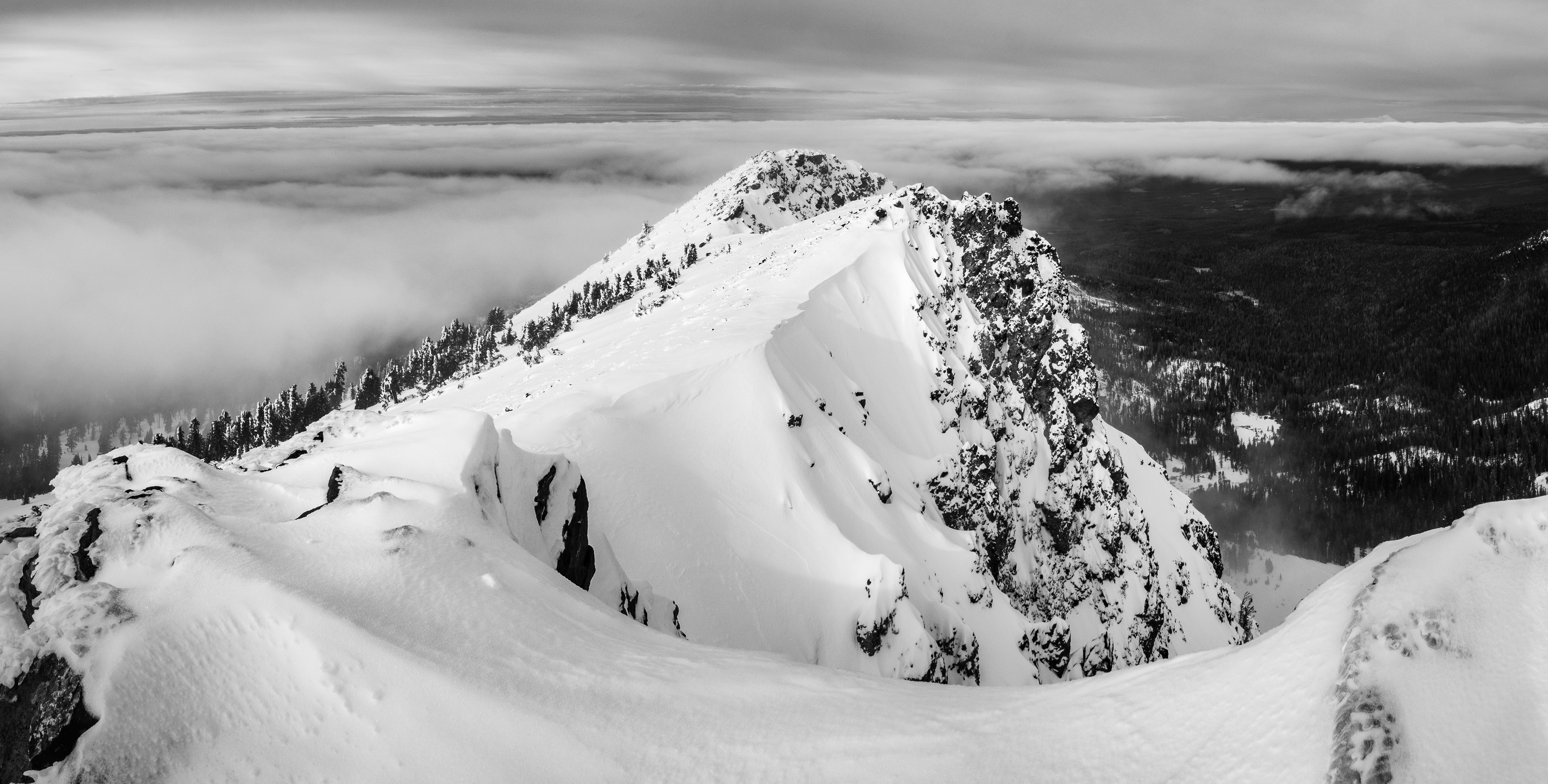 A Snow Covered Brokeoff Mountain Above the Clouds