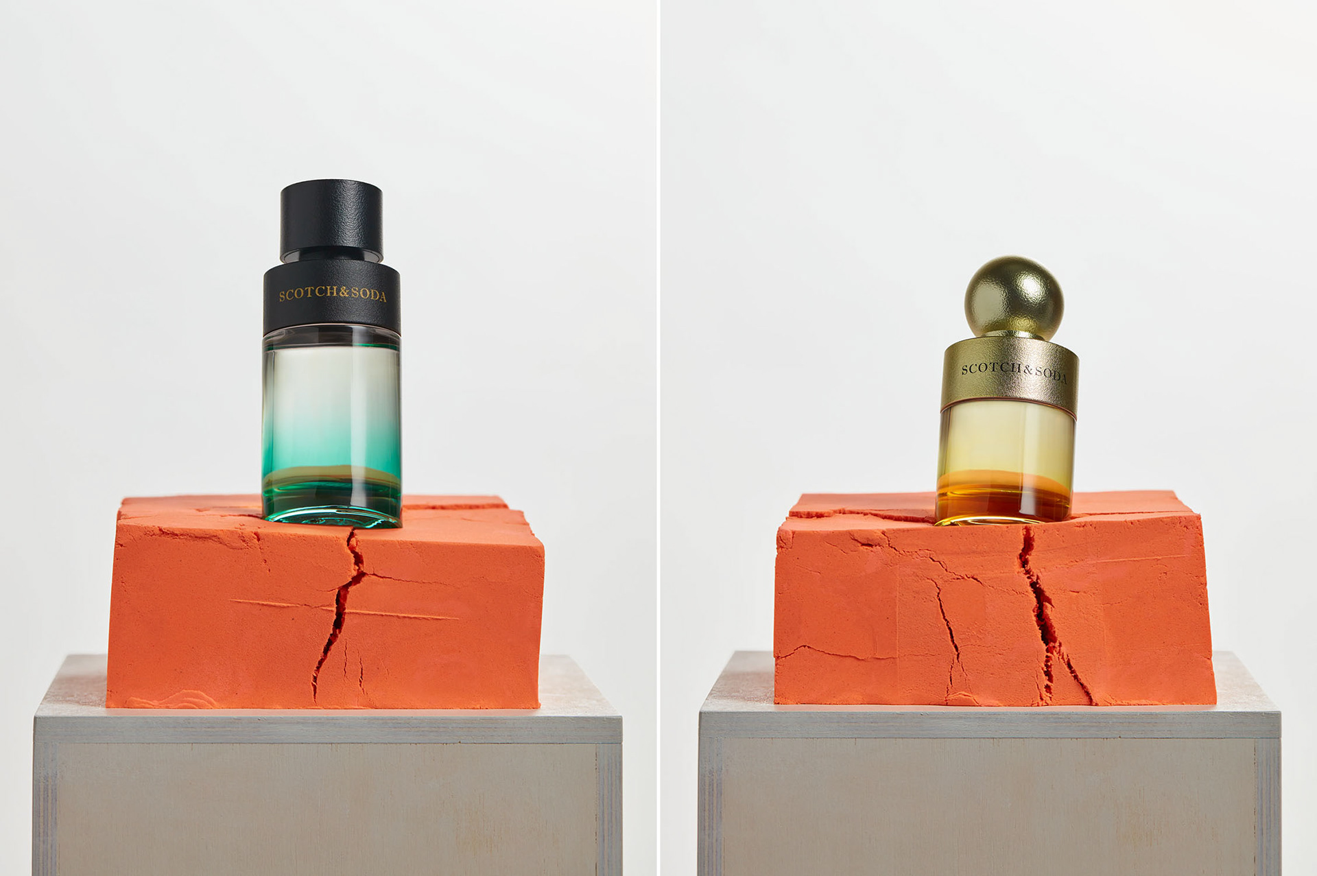 Studio image of perfume bottles rest on orange-colored kinetic sand and slowly sink.
