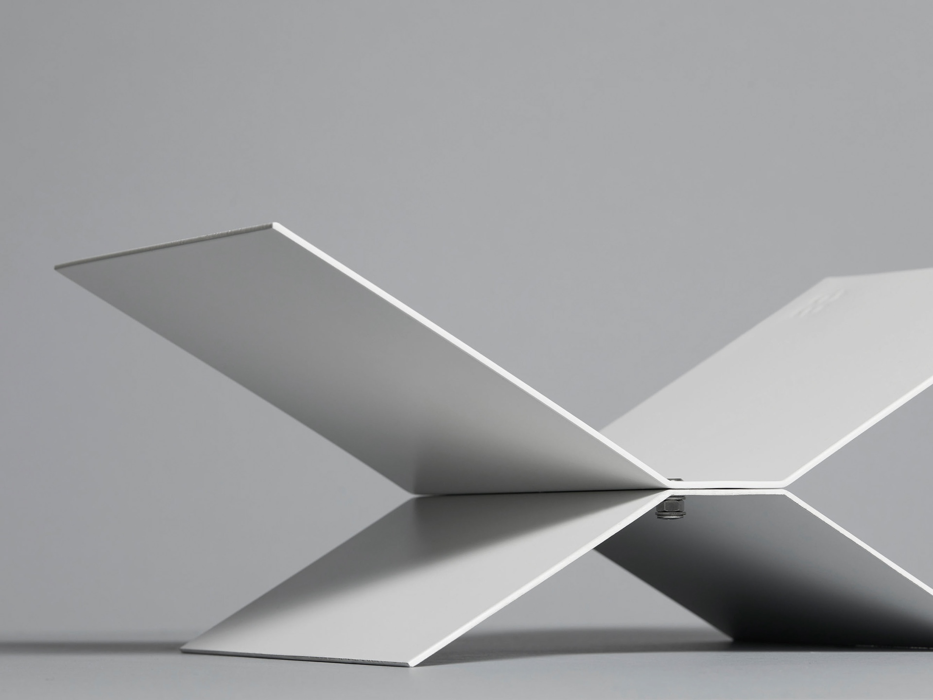 Product photo of bookstand highlighted with soft light on a neutral background showing how the product can be constructed