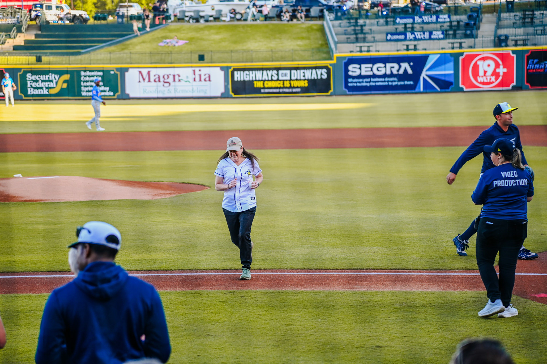 Dean Sabo-Attwood running off the field after thowing the first pitch of the baseball game.