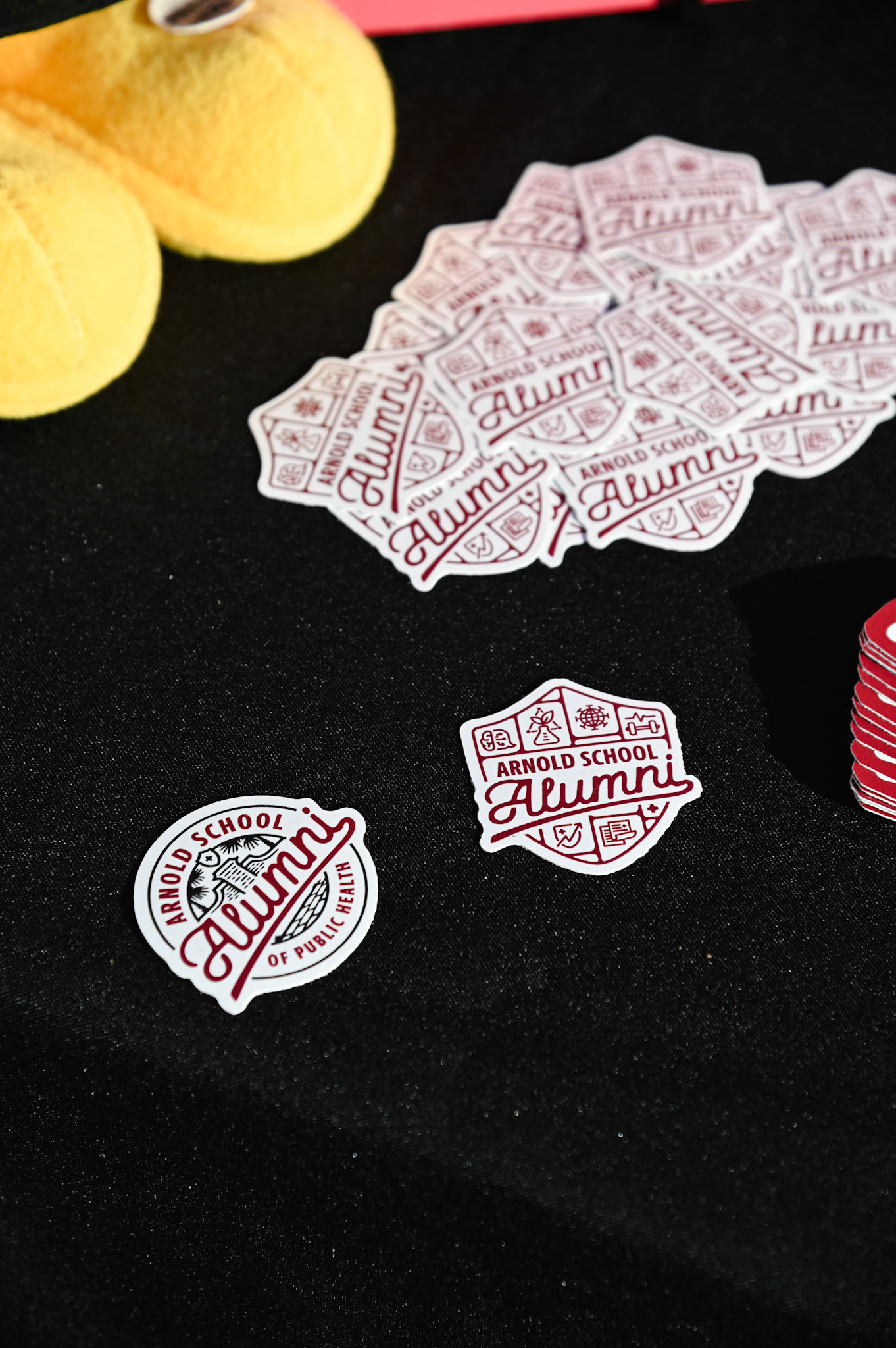 Closeup of Arnold School Alumni stickers on a table
