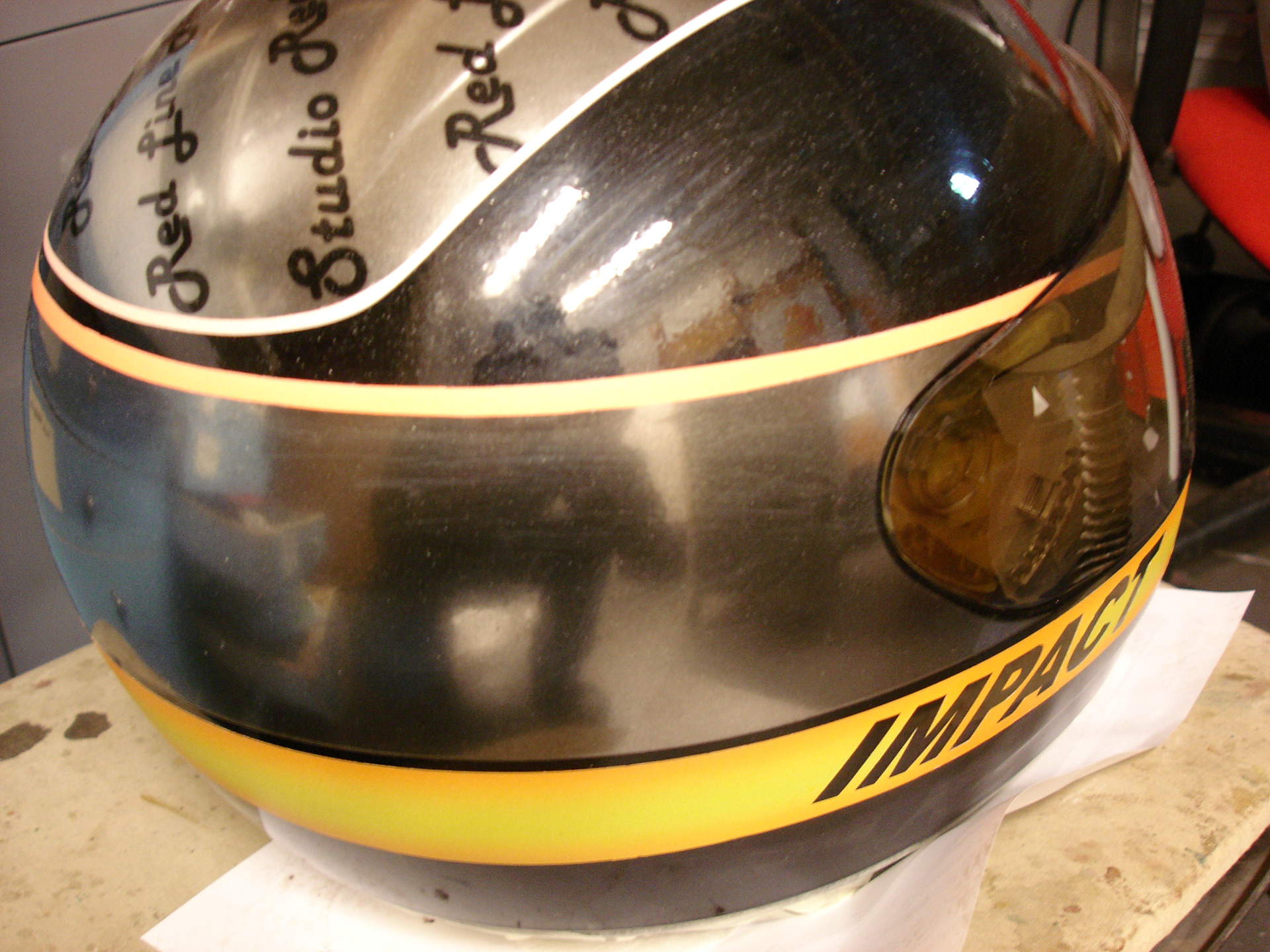 Chrome-effect impact logo airbrushed on helmet
