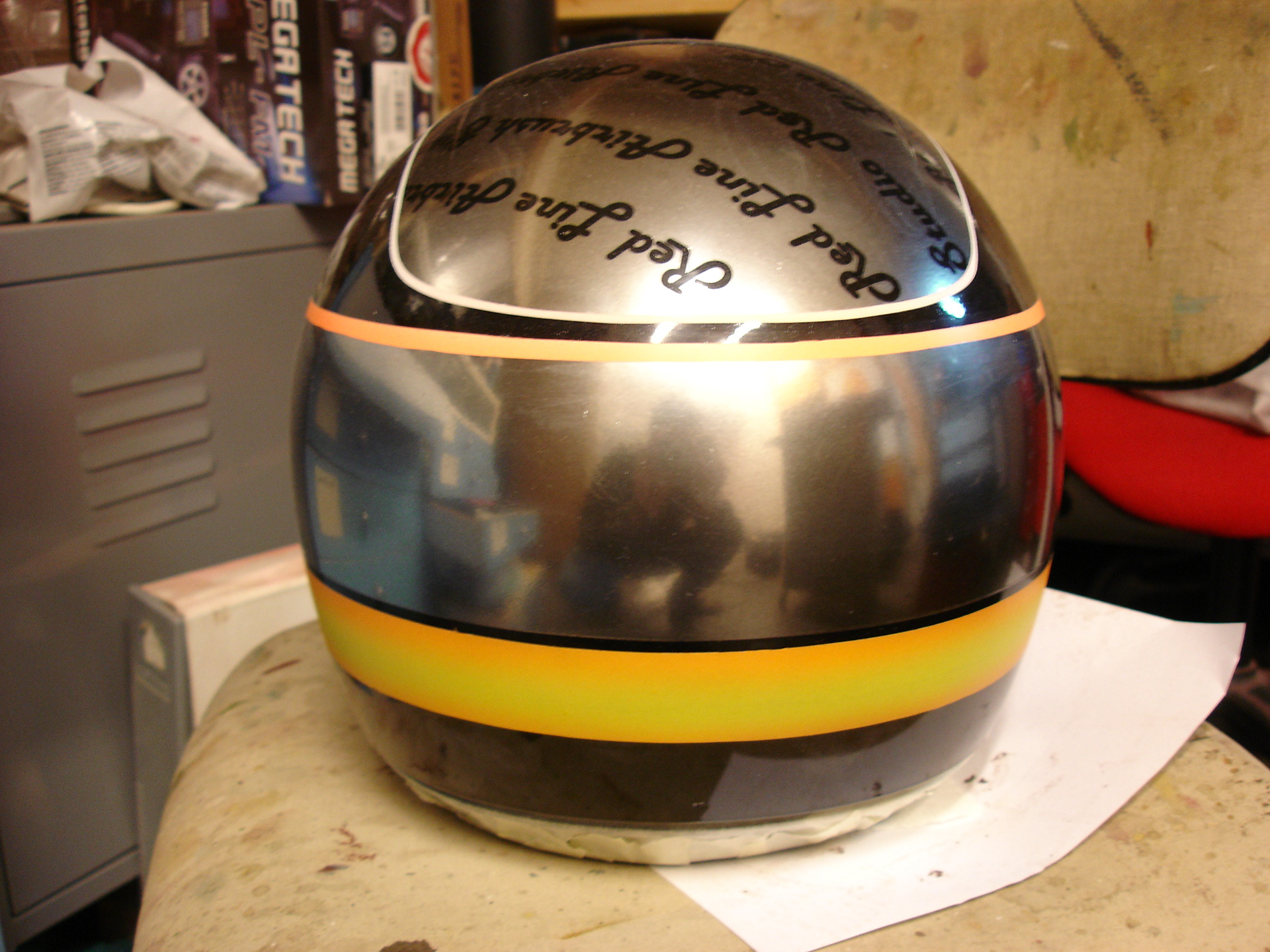 Chrome-effect impact logo airbrushed on helmet