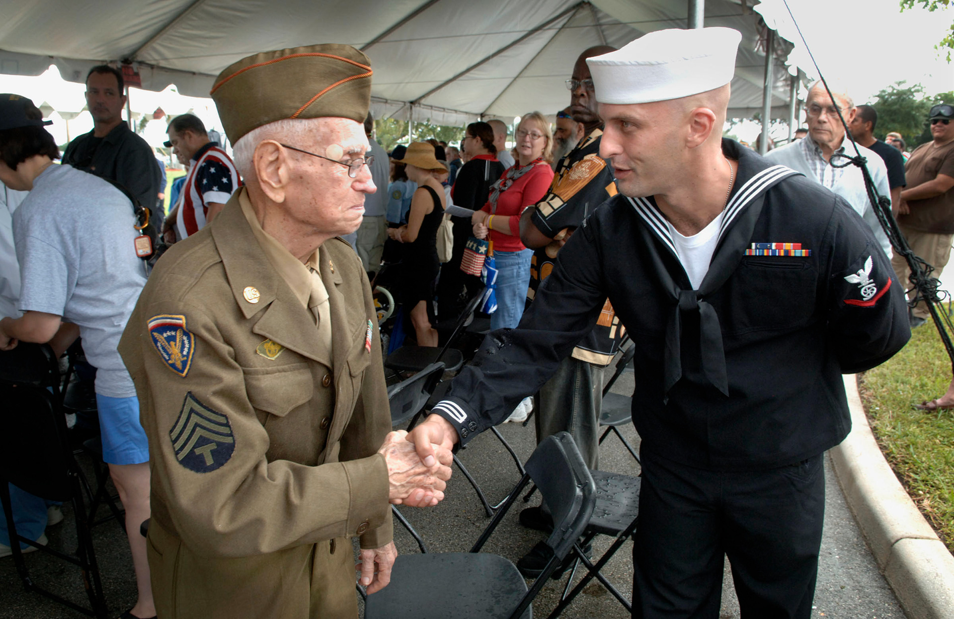 World War II veteran Rudy Johansky, 92, shakes hands with Navy veteran Matthew Cantone during a Veteran's Day ceremony in Tamarac, Fl. in 2009. .  