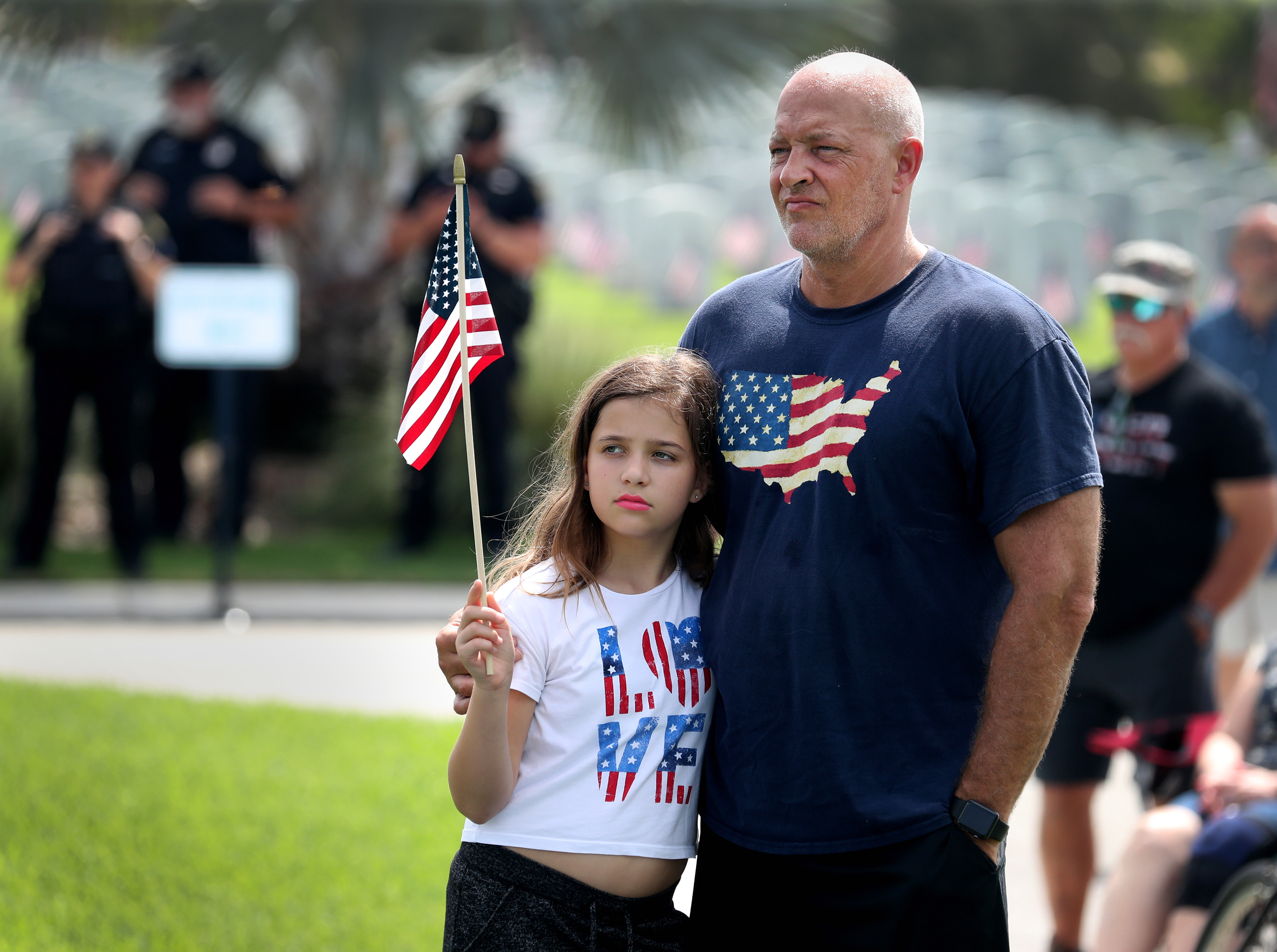 Natalie McGinty, 10, and her father, Jeff, an Air Force veteran, attend South Florida National Cemetery's 16th Annual Memorial Day Ceremony on May 30, 2022 in Lake Worth, Fl. 