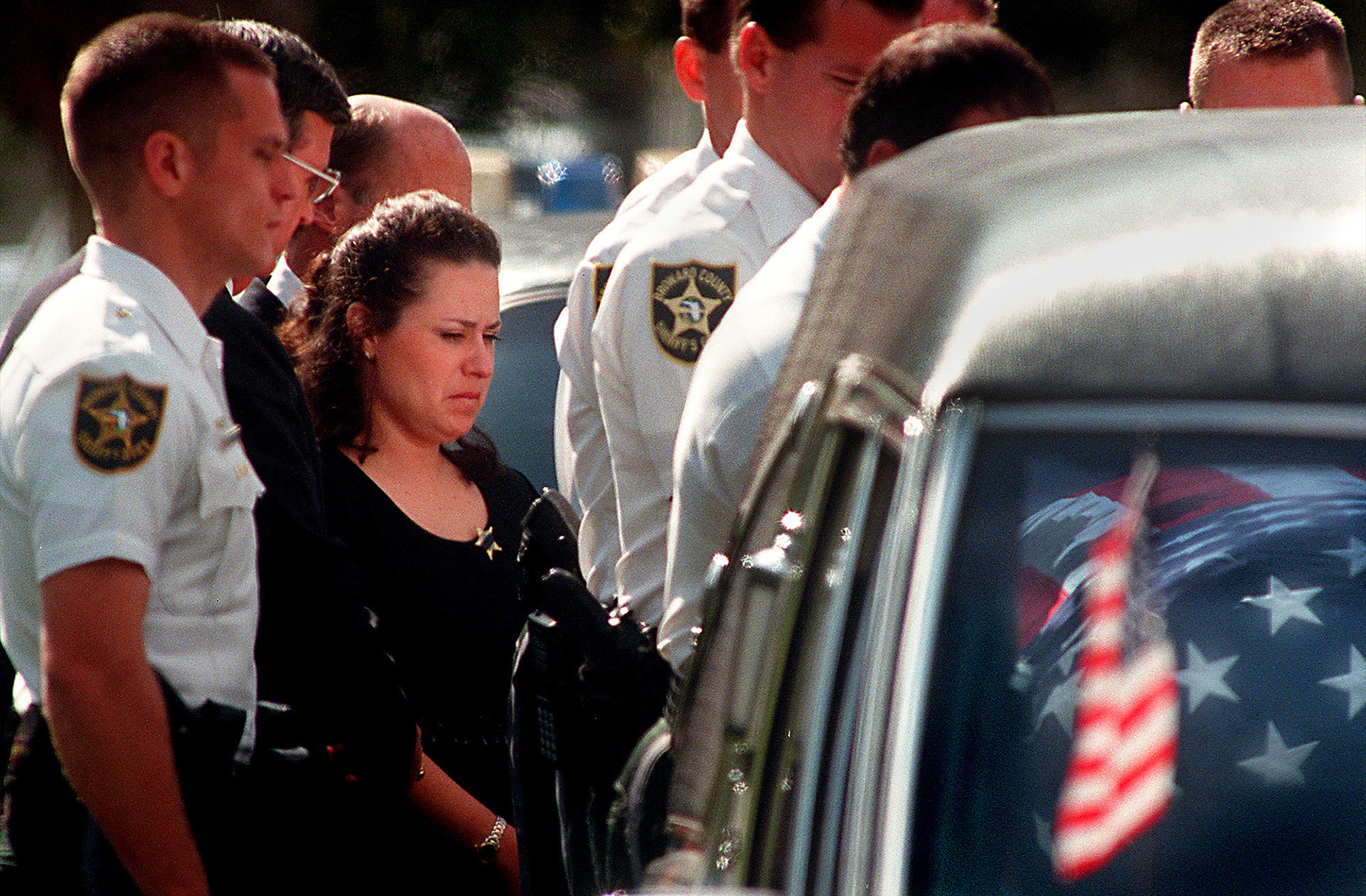 Donna Revera, wife of Broward Sheriff's Office deputy Donald Revera, watches as her husband's casket is put into the hearse after the funeral service in Plantation, Fl in 1998.